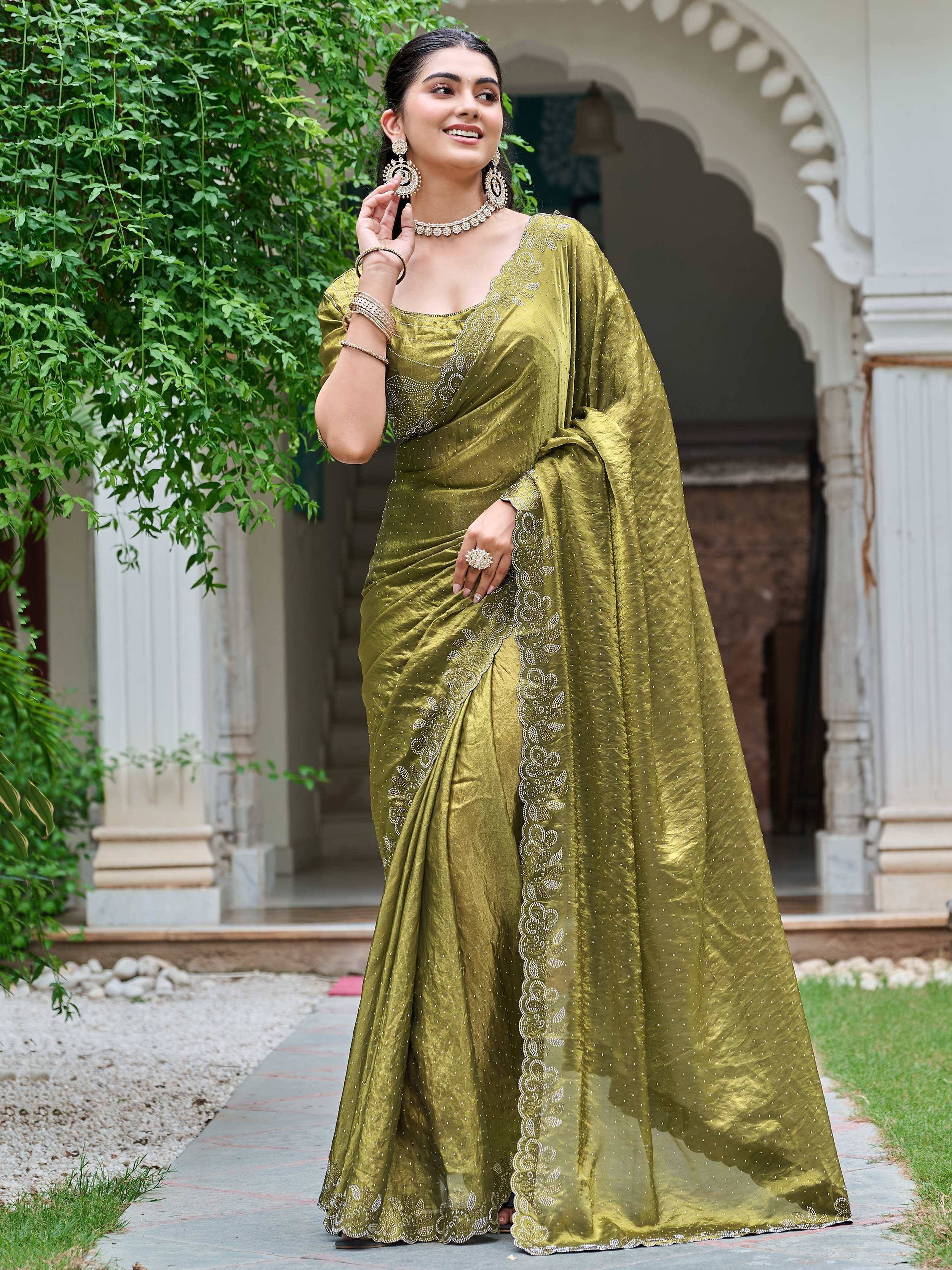 Elegant olive green saree with intricate embroidery and embellishments, perfect for ethnic occasions.