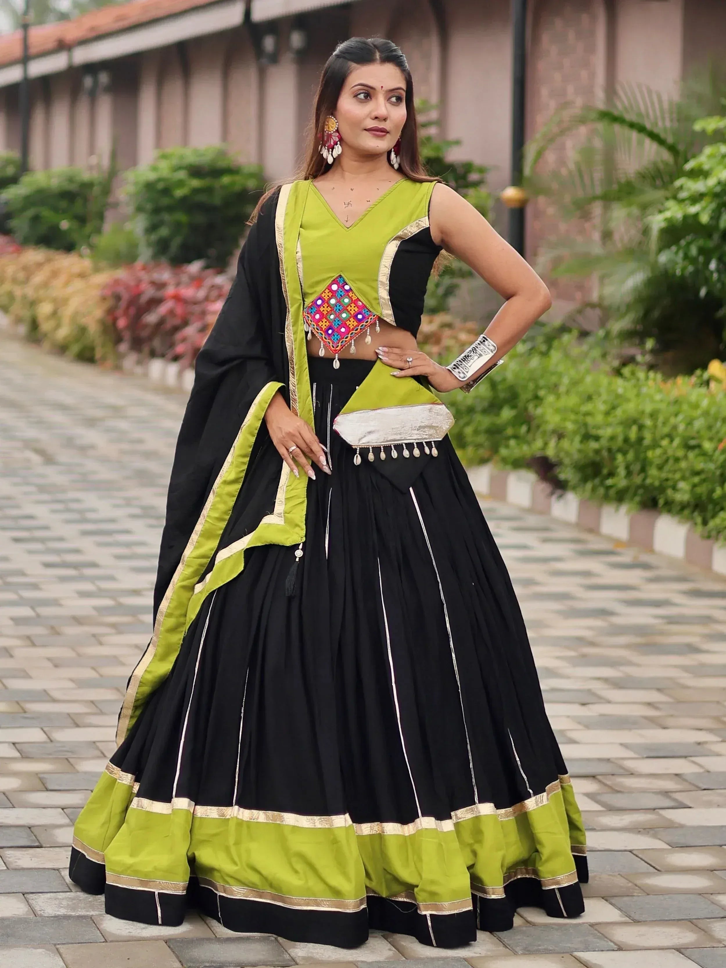 Black and lime green ethnic lehenga choli with mirror work, perfect for Indian weddings and festive occasions.