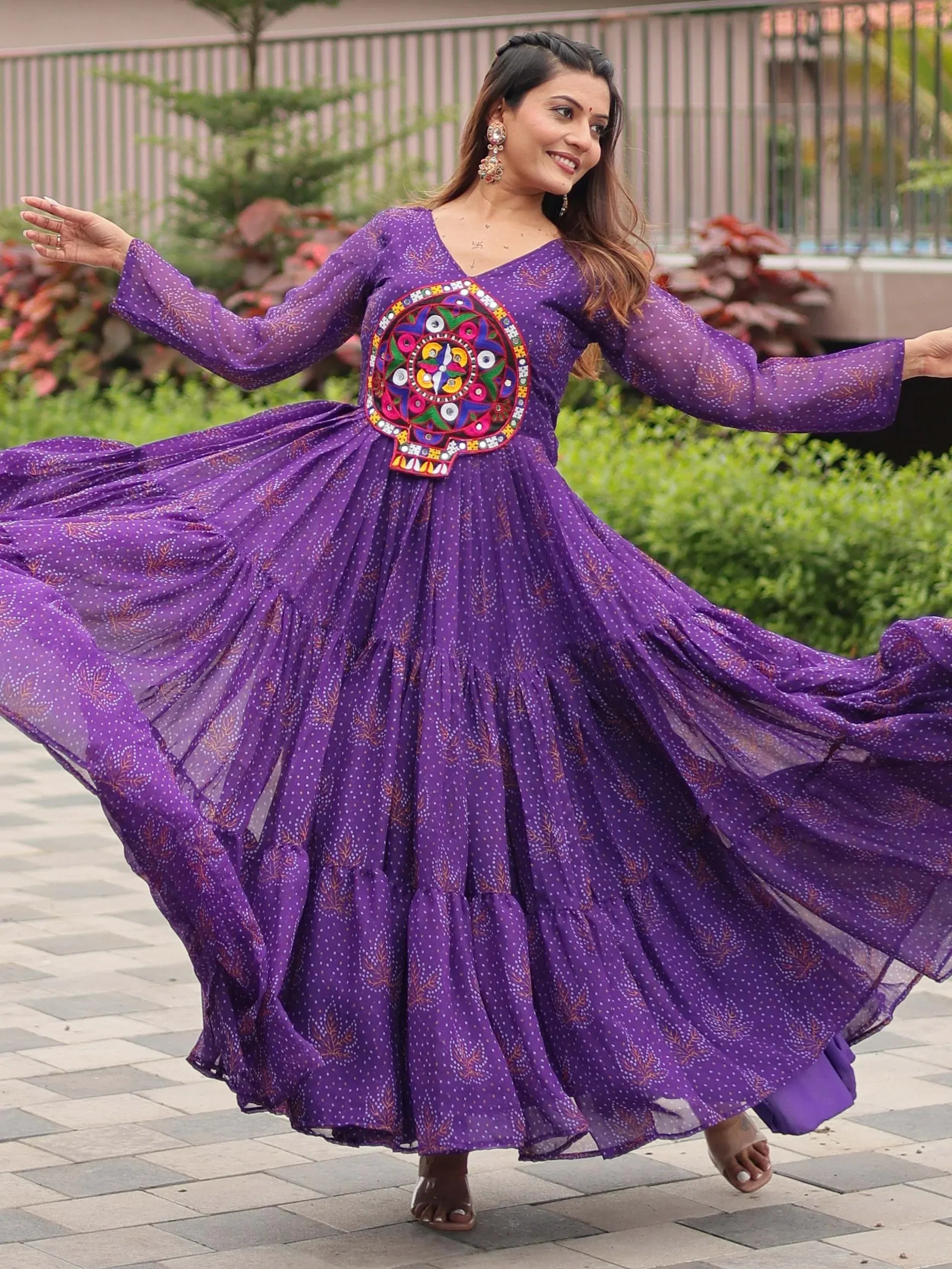 Purple ethnic gown with vibrant embroidery, perfect for festive occasions and traditional celebrations.