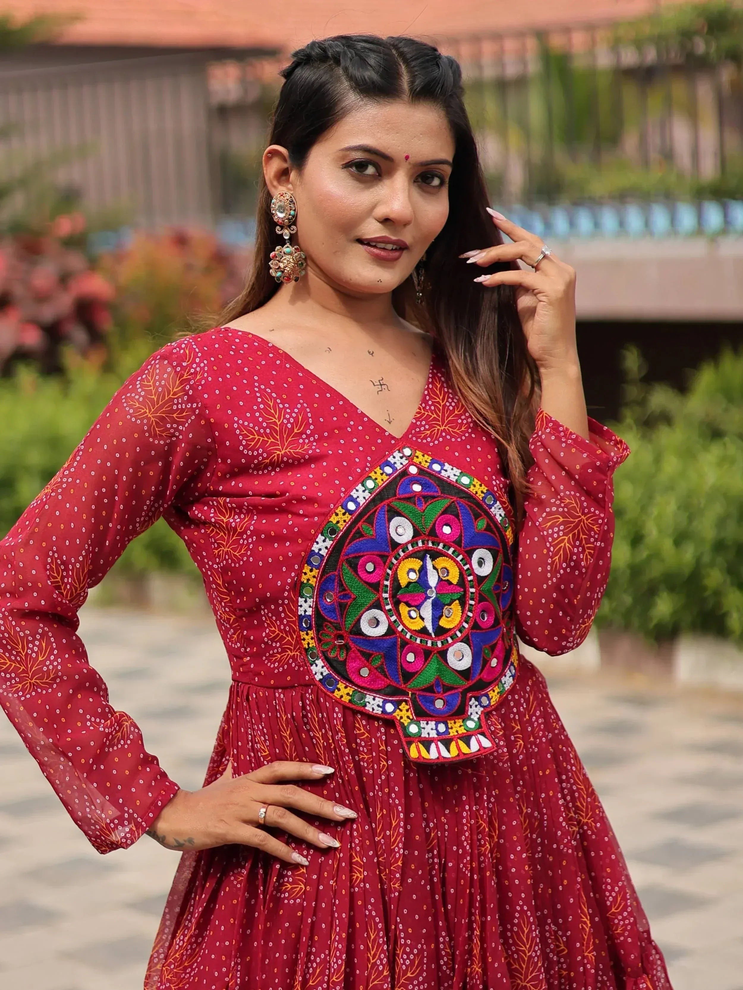 Woman in red ethnic gown with colorful mirror embroidery, perfect for Indian festive occasions