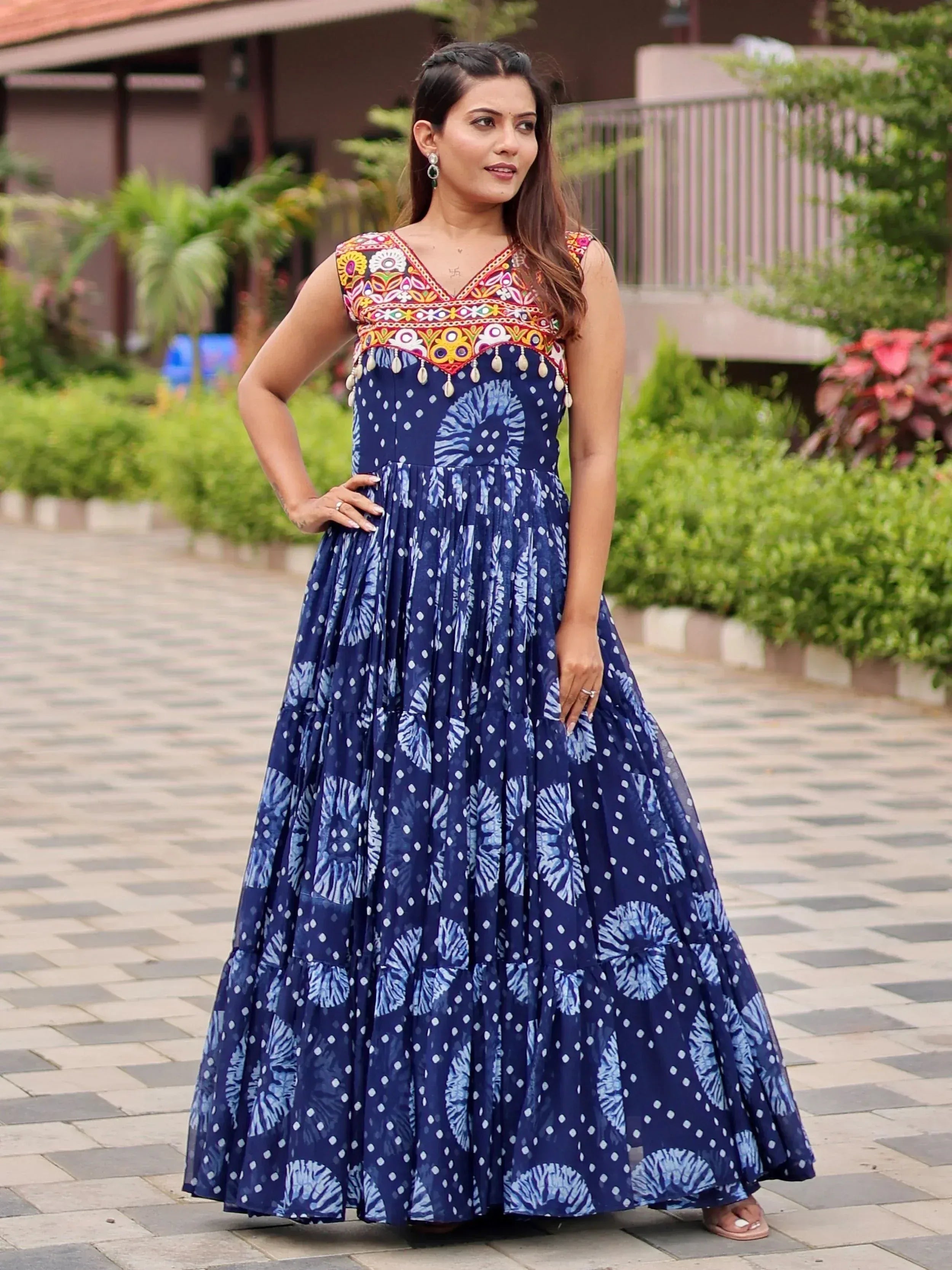 Blue printed ethnic gown with colorful embroidered neckline and tassels, perfect for festive occasions