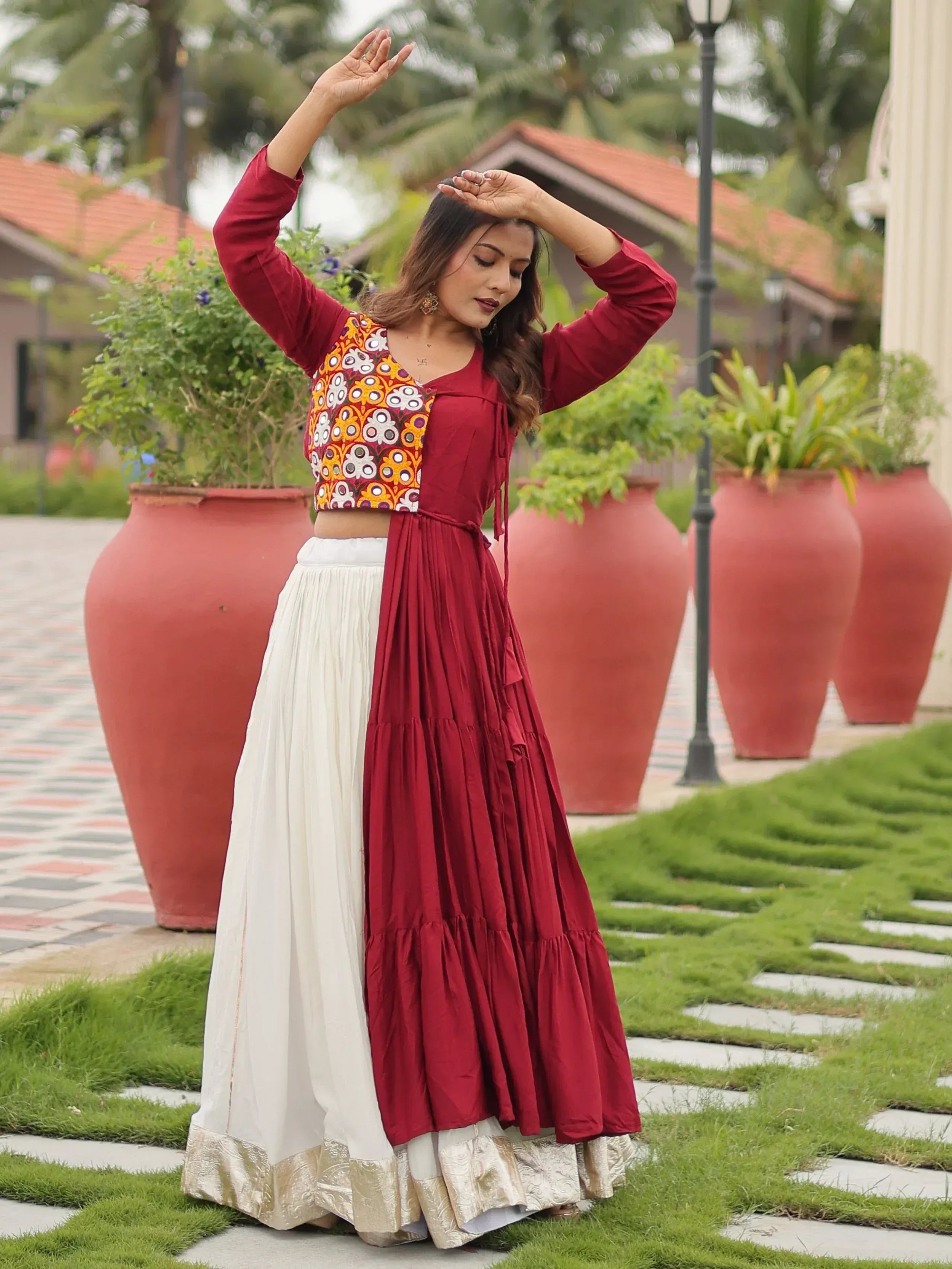 Woman in maroon and white ethnic lehenga with floral embroidery, perfect for Indian festivals and weddings