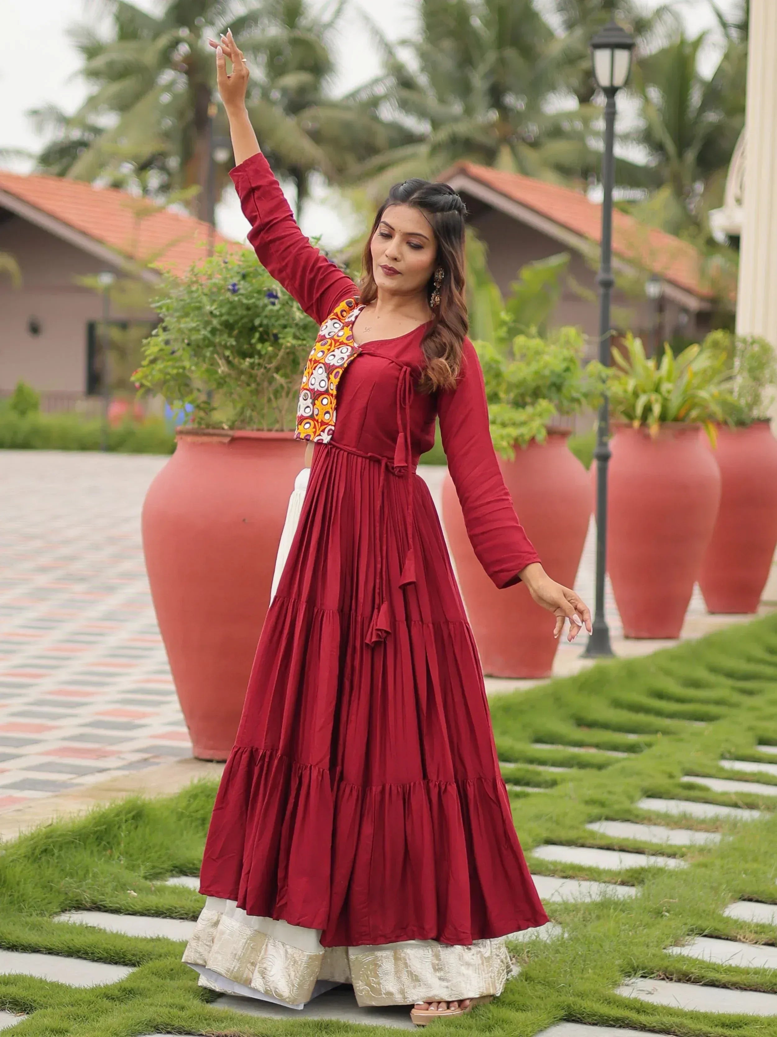 Woman in maroon ethnic gown with printed jacket, perfect for Indian occasions and festive wear