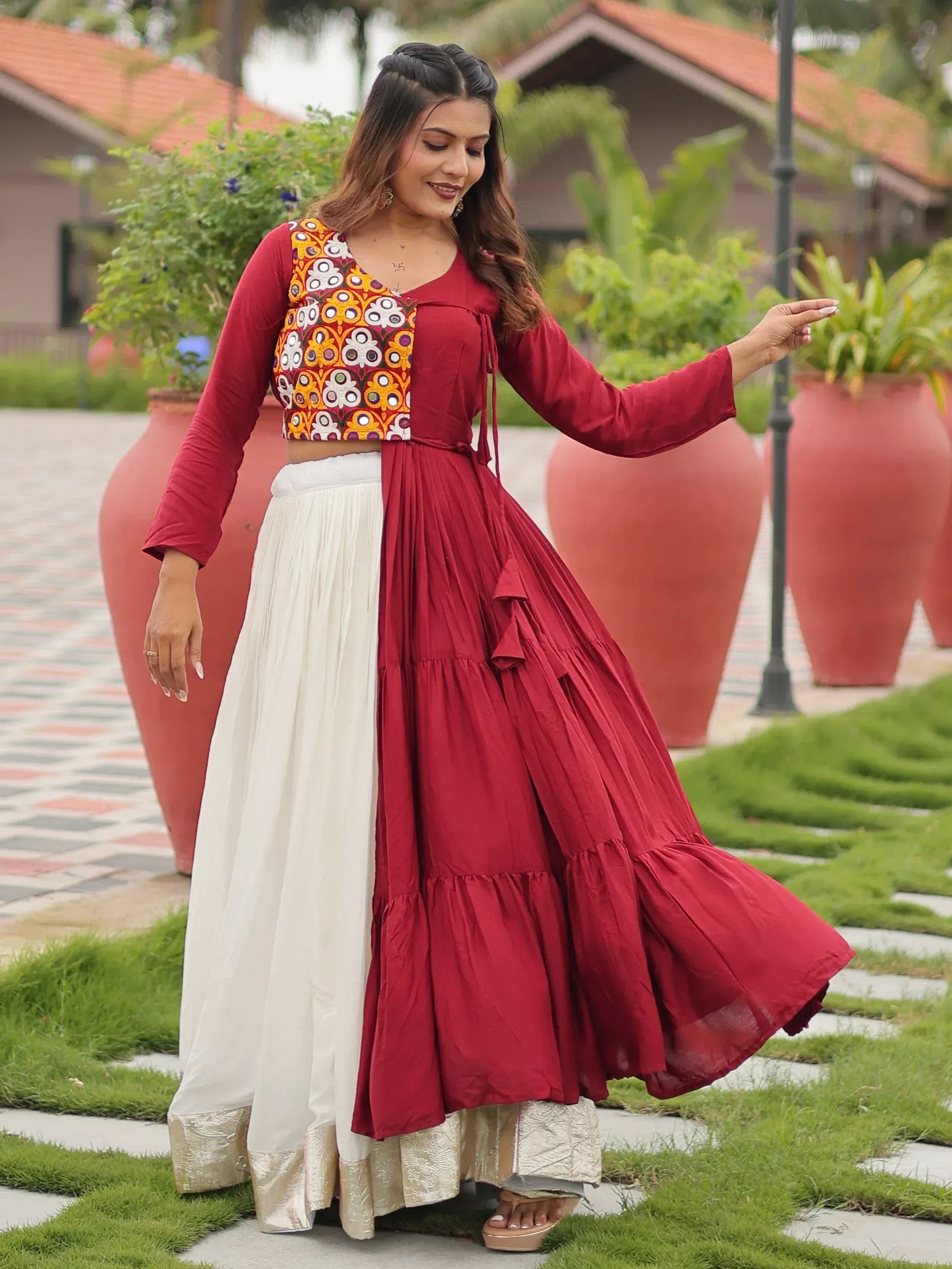 Woman in maroon and white ethnic gown with embroidered crop top, perfect for Indian festive occasions