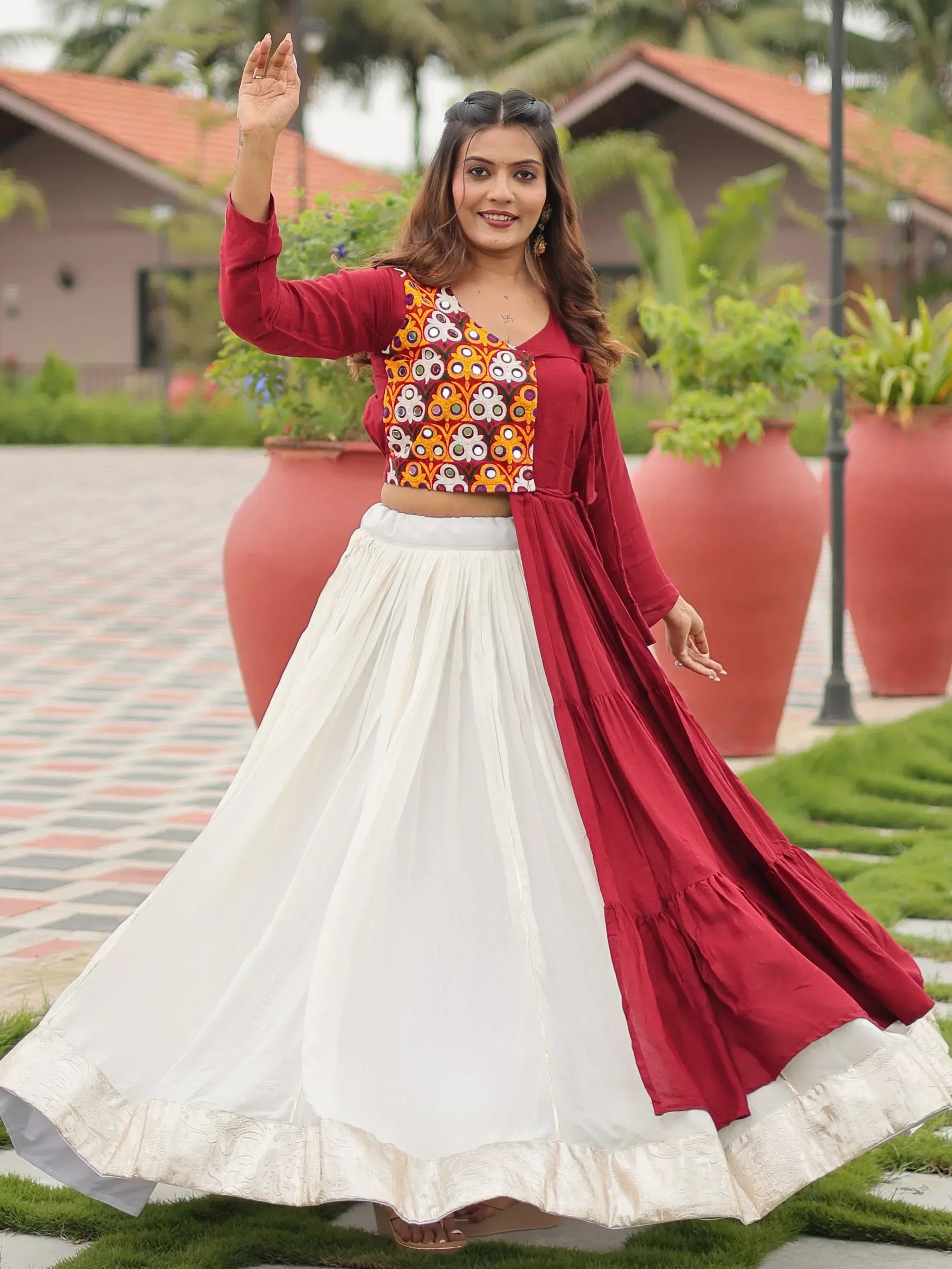 Woman in maroon and white ethnic lehenga choli with mirror work, perfect for Indian festivals and weddings