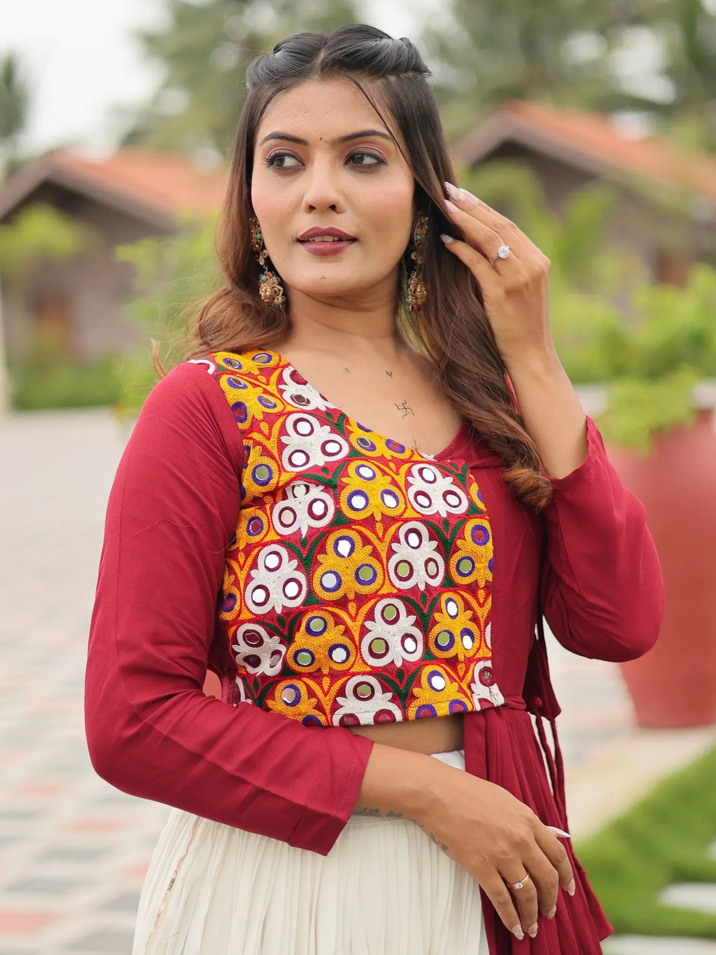 Maroon ethnic top with mirror work embroidery, paired with white skirt, perfect for Indian festive wear