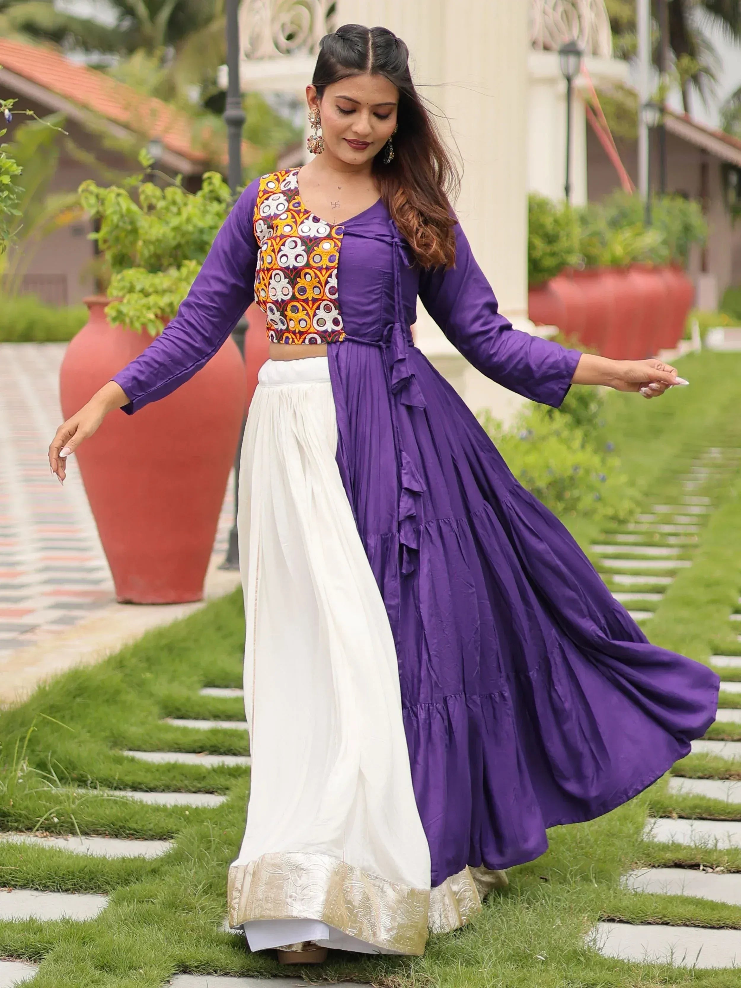 Purple and white ethnic gown with floral embroidery, perfect for Indian festive occasions.