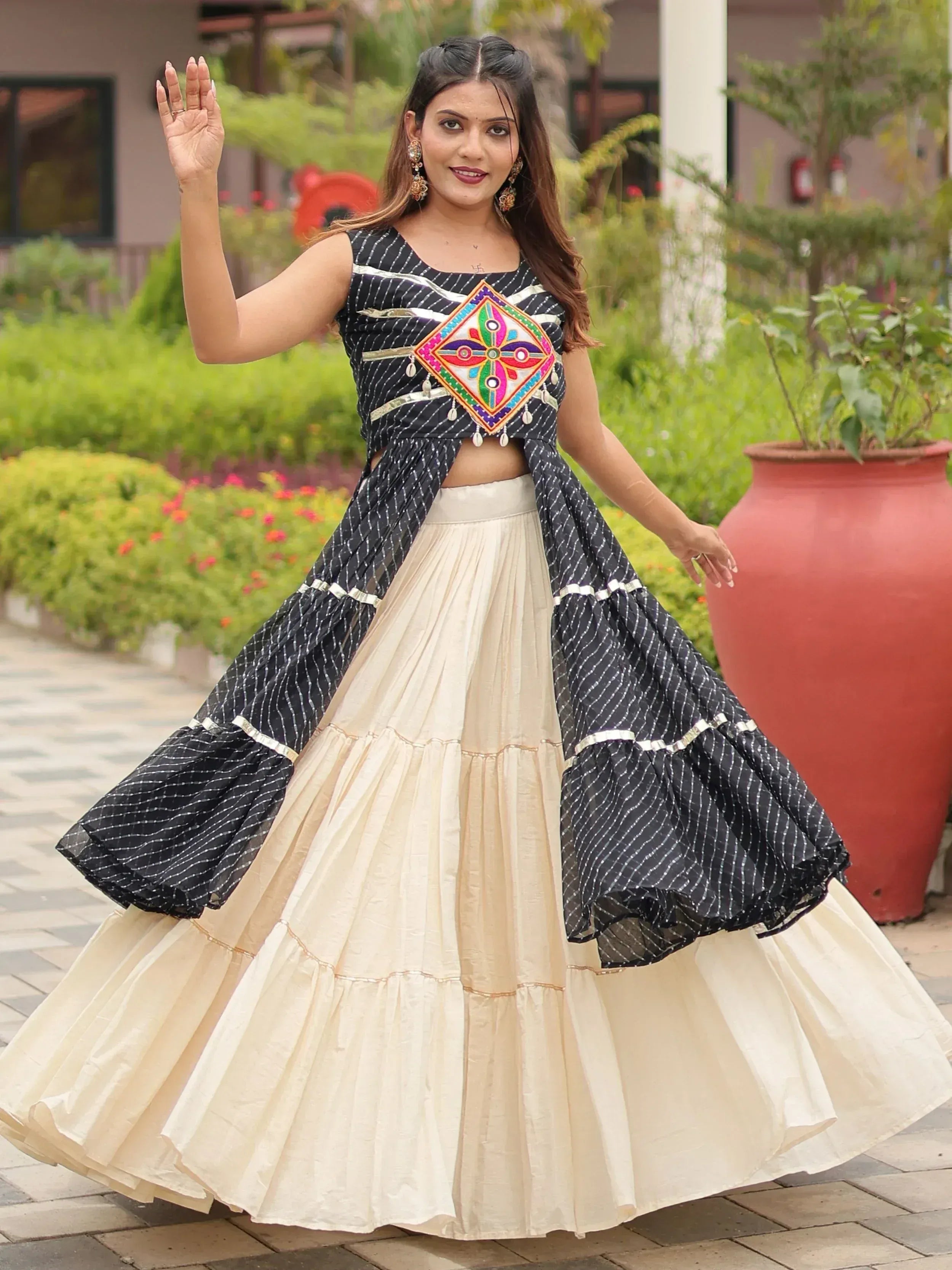 Elegant black and cream ethnic lehenga with colorful embroidery, perfect for festive occasions.