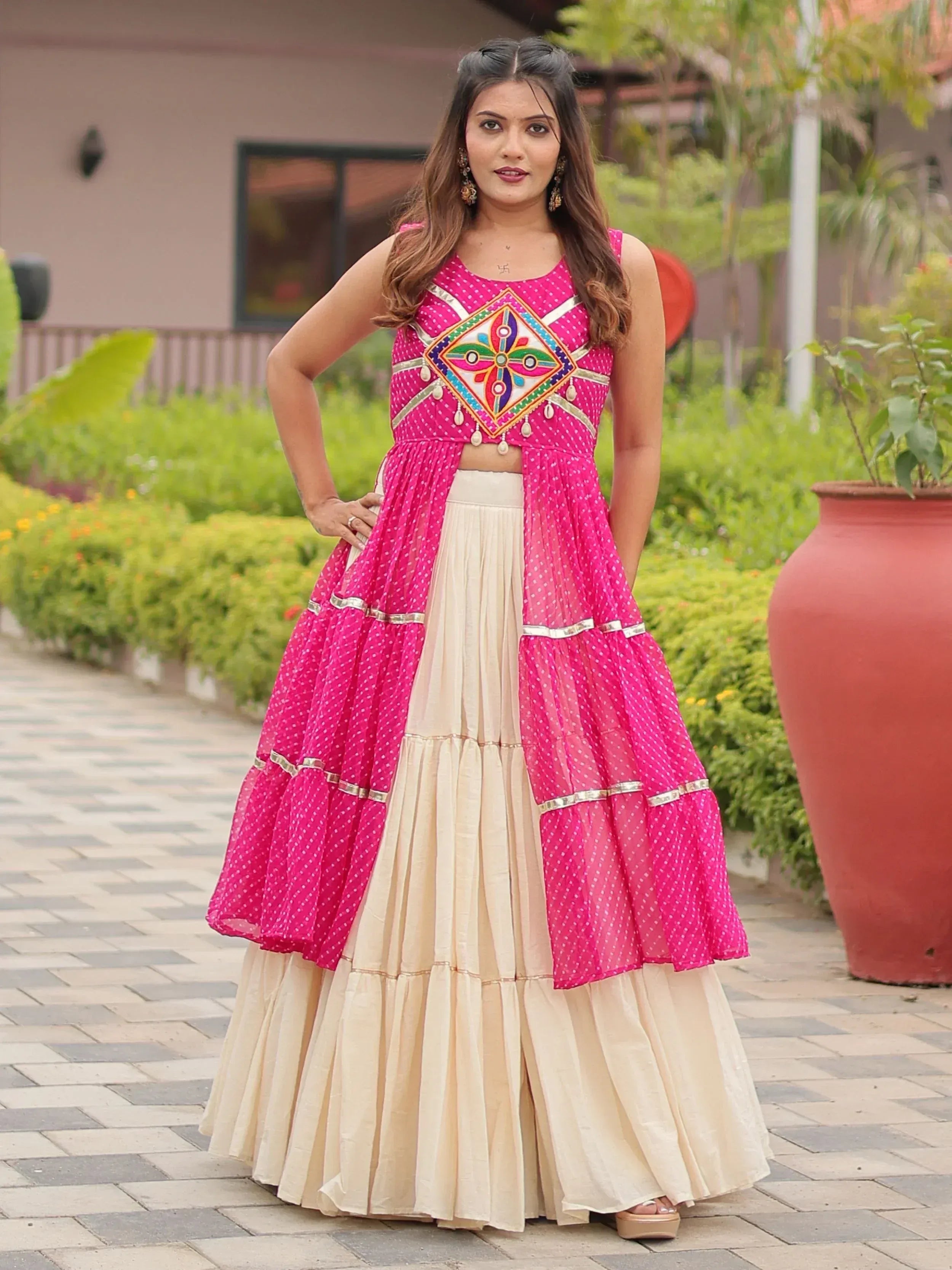 Pink and cream ethnic lehenga choli with mirror work, perfect for Indian weddings and festive occasions.
