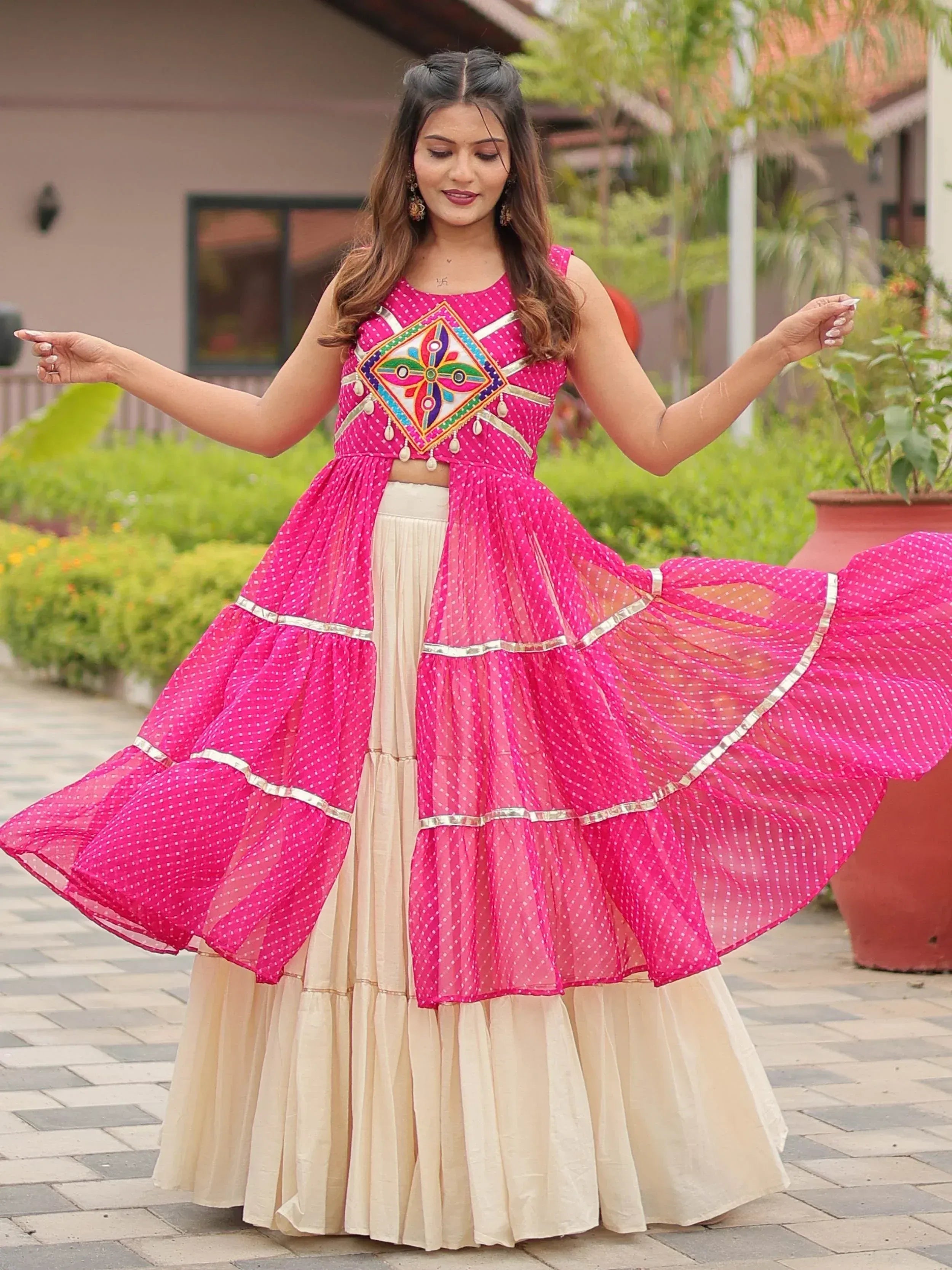 Pink polka dot lehenga choli with embroidered top and flared skirt, perfect for Indian ethnic wear