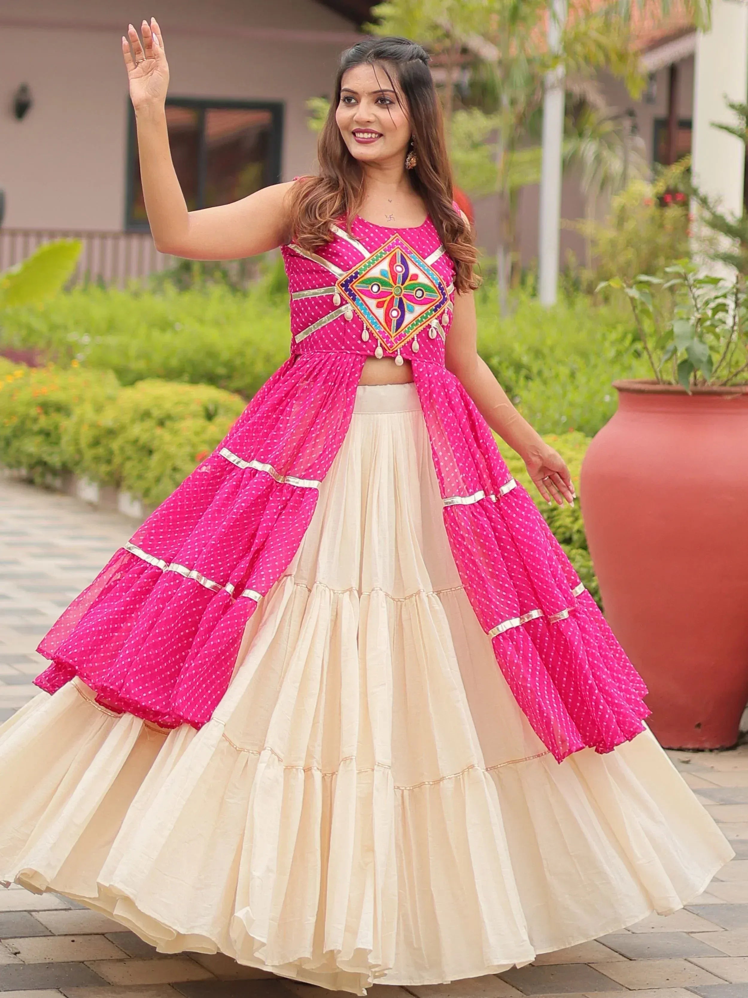 Pink and cream ethnic lehenga choli with mirror work, perfect for Indian weddings and festive occasions.