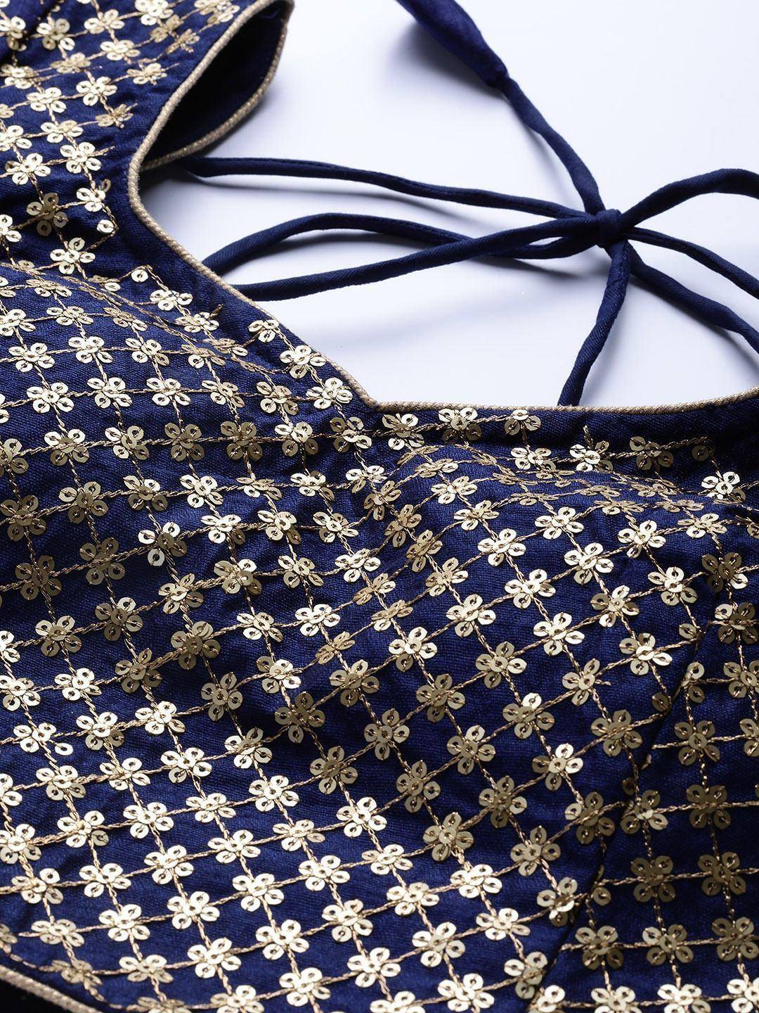 Navy blue designer blouse with gold floral embroidery and tie-back detail, perfect for ethnic wear.