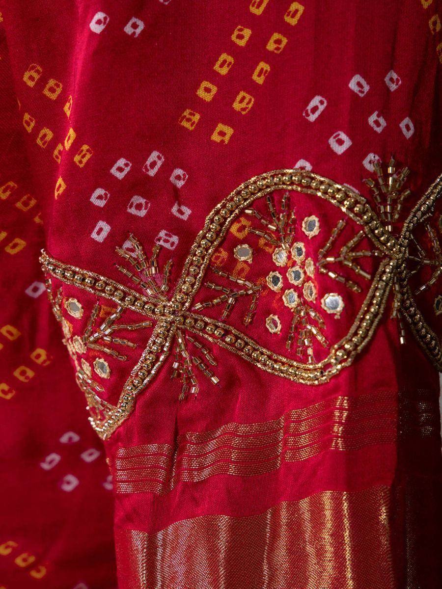 Red ethnic gown with gold beadwork and mirror embroidery, perfect for Indian festive occasions