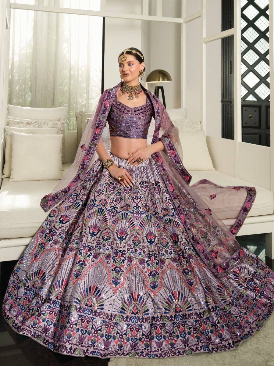 Elegant purple embroidered lehenga choli with floral motifs, perfect for Indian weddings and festive occasions.