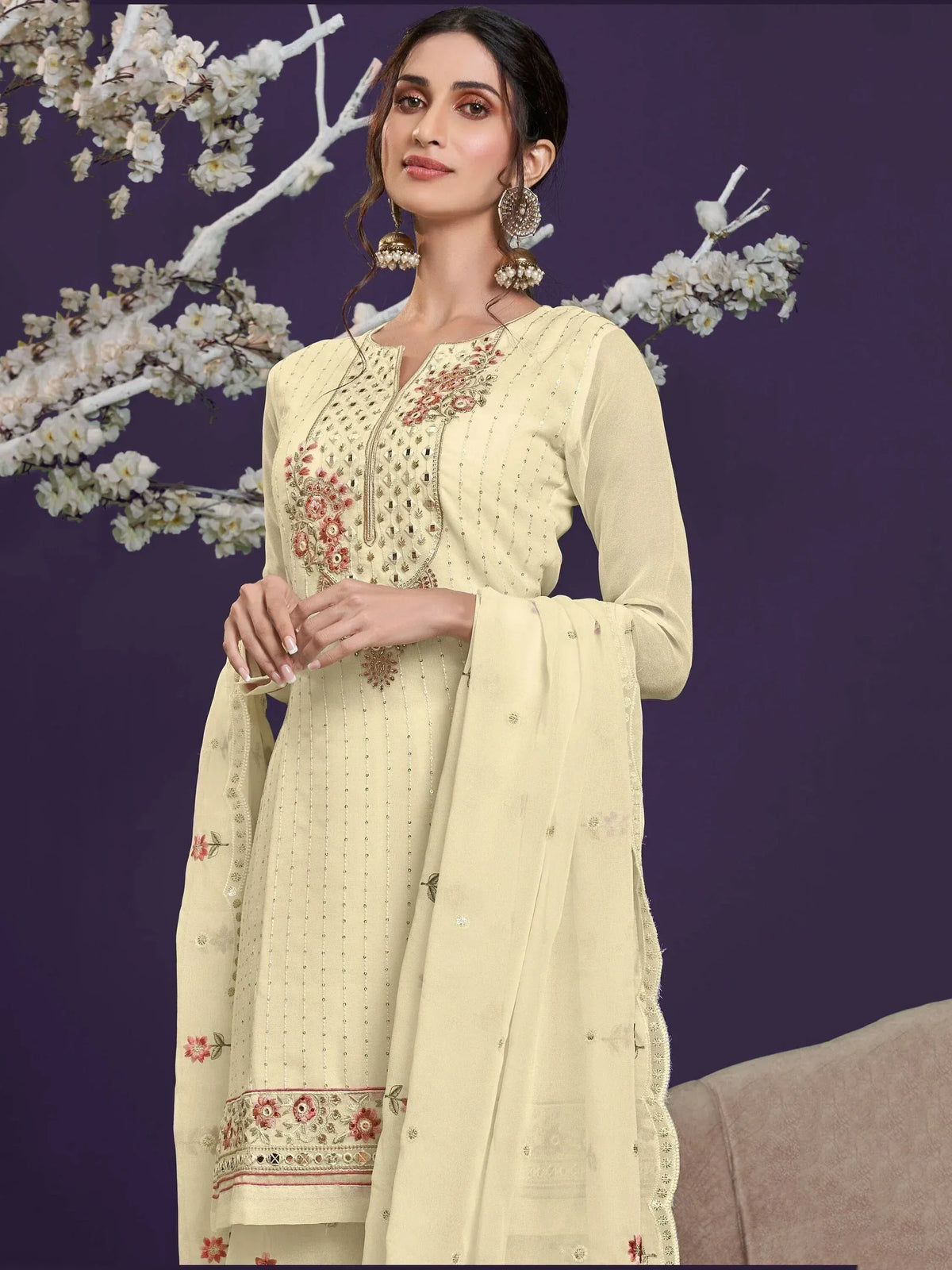 Elegant cream salwar kameez with floral embroidery and mirror work, perfect for Indian ethnic occasions