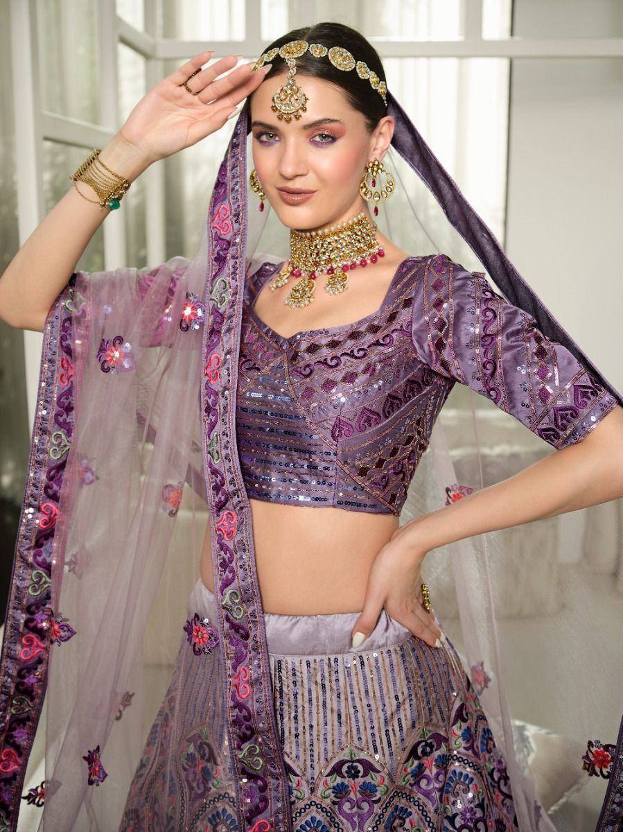 Purple embroidered lehenga choli with sequins, dupatta, and traditional jewelry for Indian ethnic wear