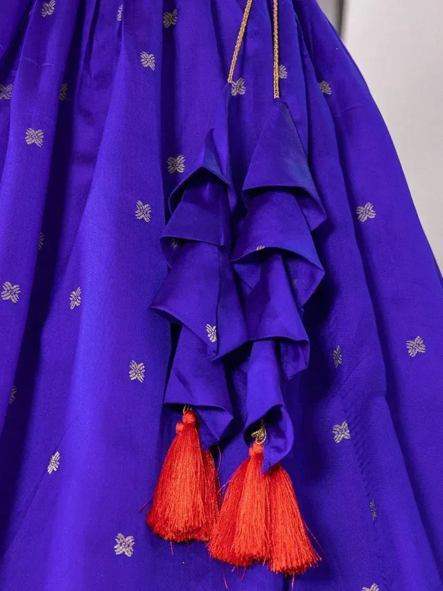 Royal blue ethnic gown with gold floral embroidery and red tassels, perfect for Indian occasions