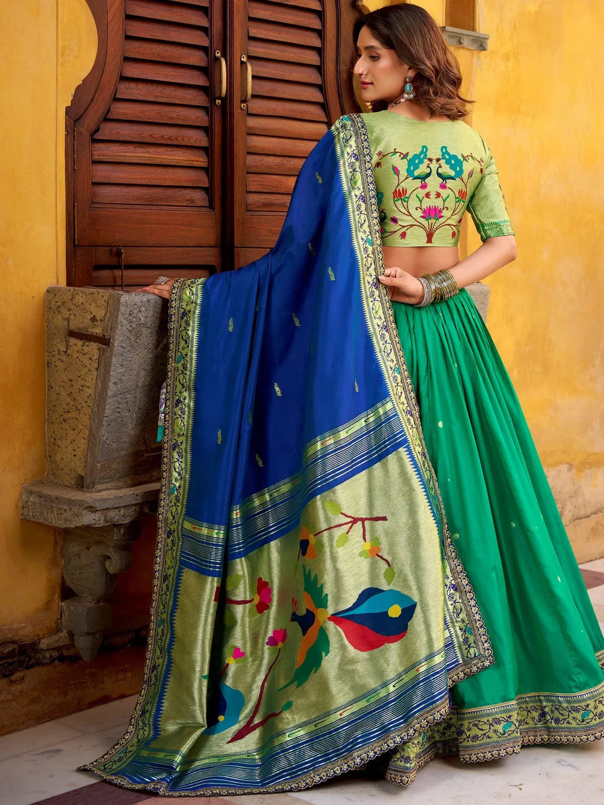 Green embroidered lehenga choli with blue dupatta, floral peacock design, ethnic Indian wear