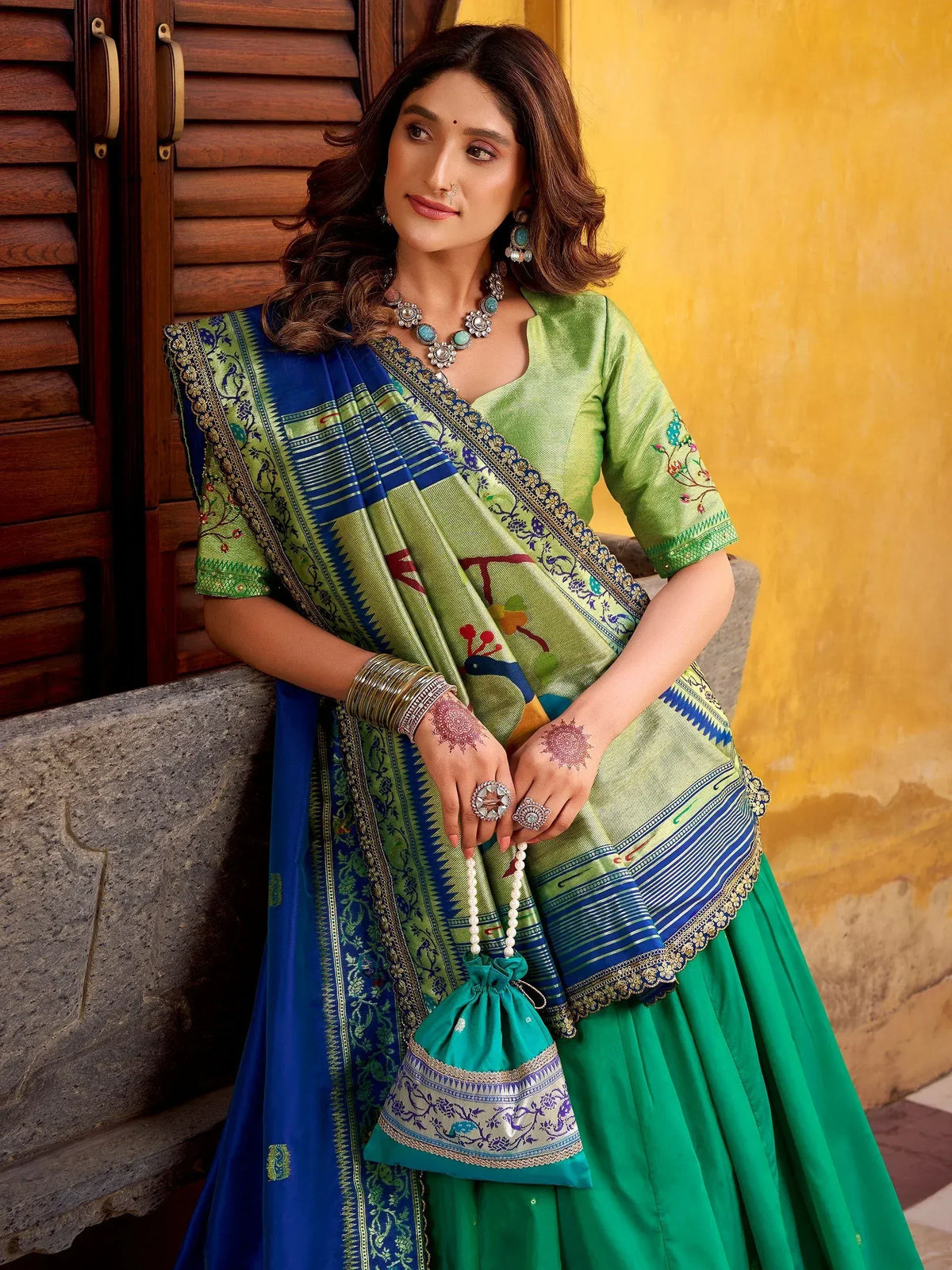 Green and blue embroidered lehenga choli with peacock motifs, perfect for Indian ethnic wear occasions.