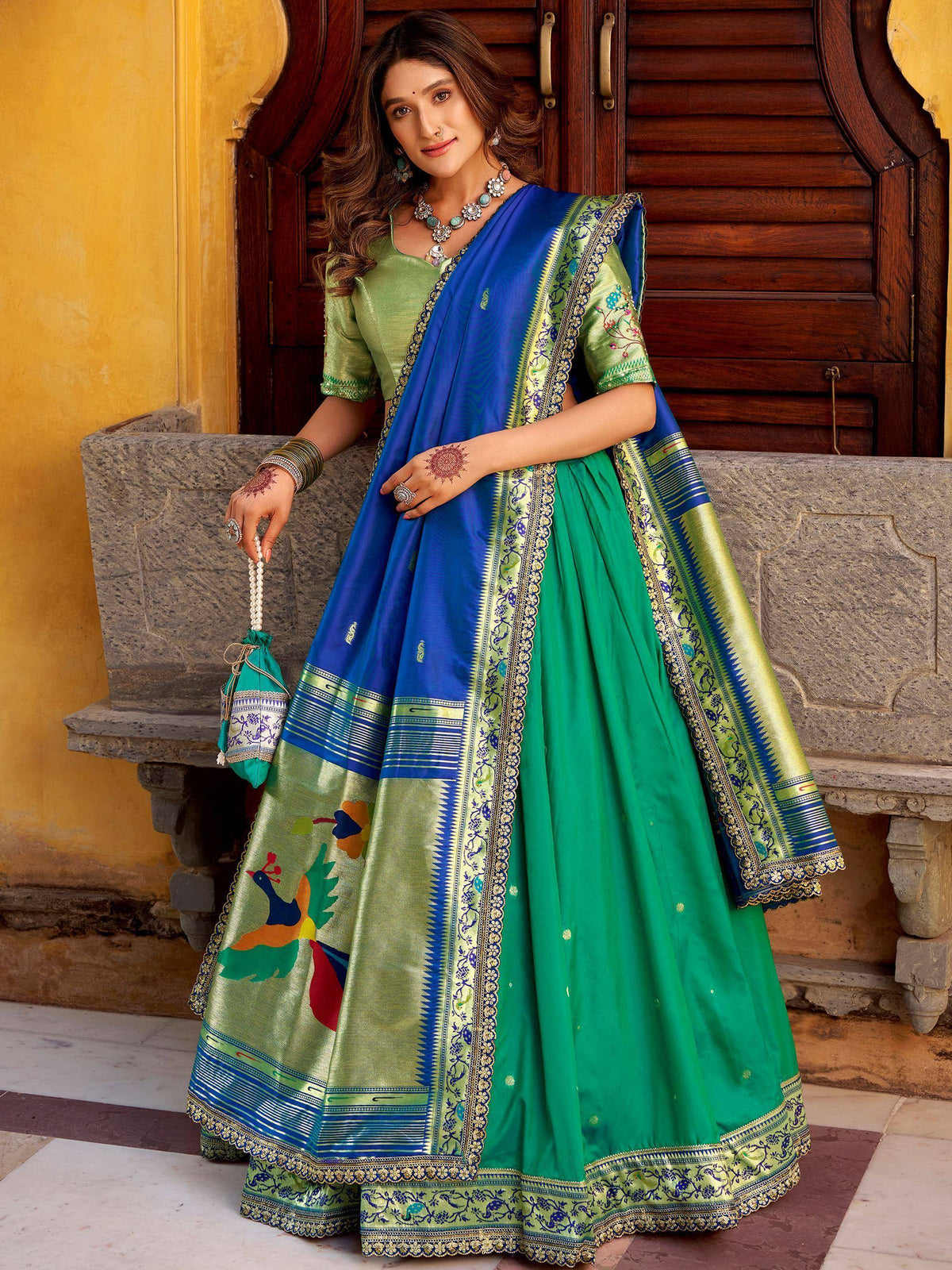 Green and blue designer lehenga choli with peacock embroidery, perfect for Indian ethnic wear occasions.