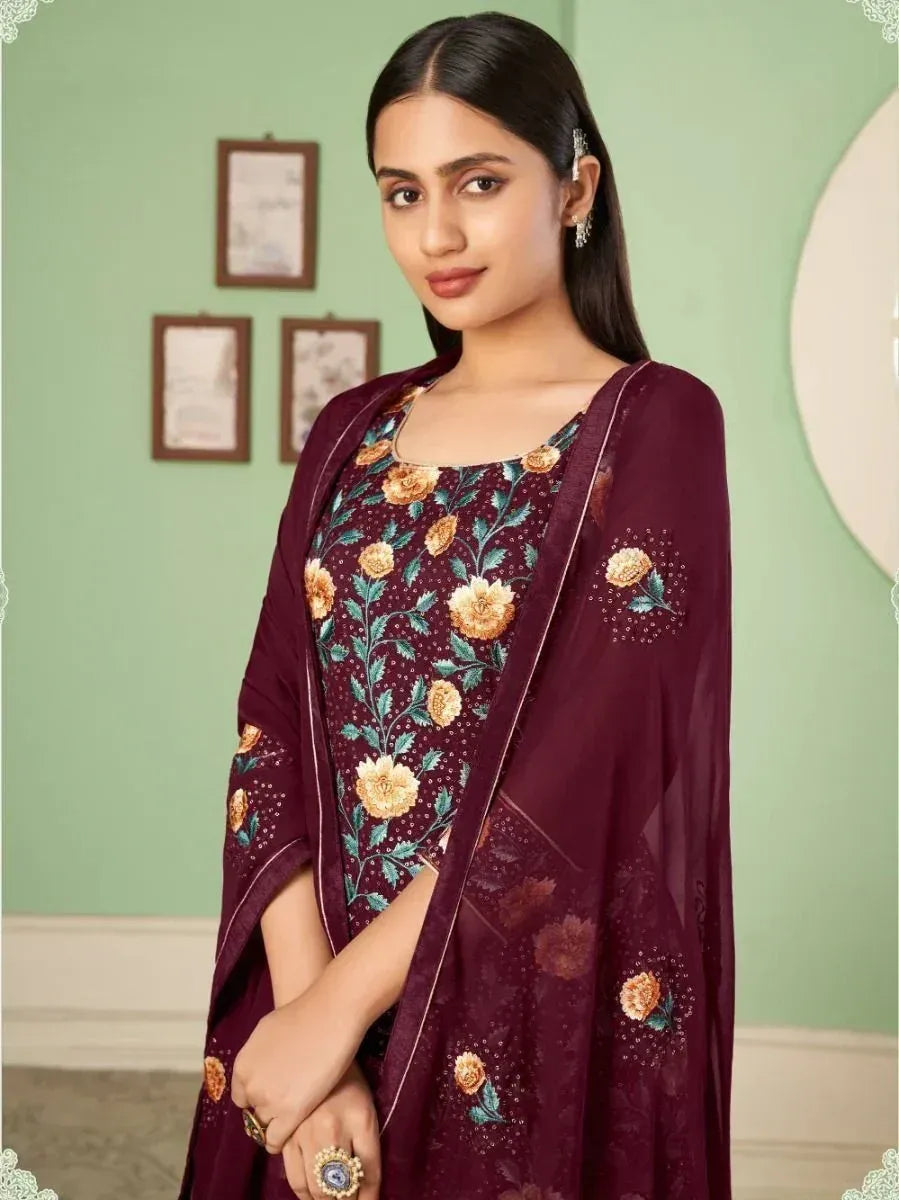 Woman in maroon floral embroidered salwar kameez with matching dupatta