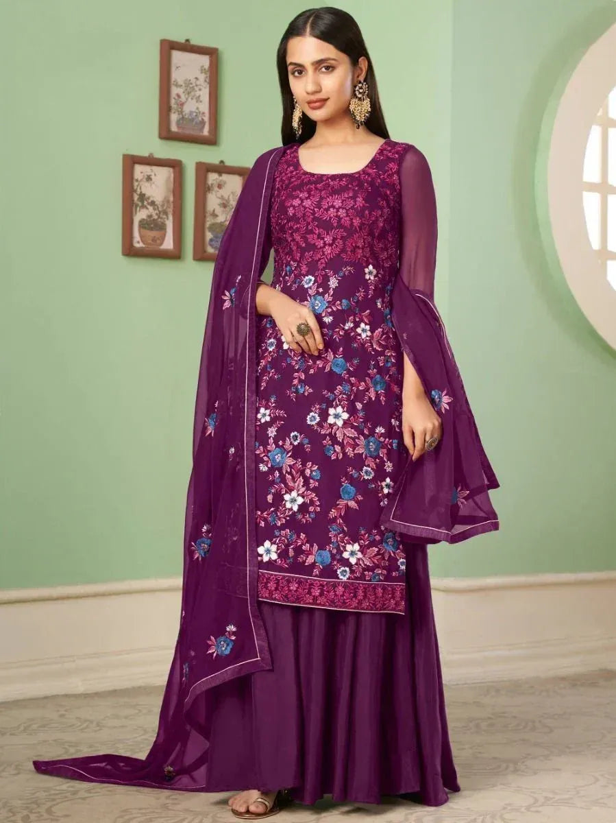 Woman wearing purple floral embroidered salwar kameez with matching dupatta indoors
