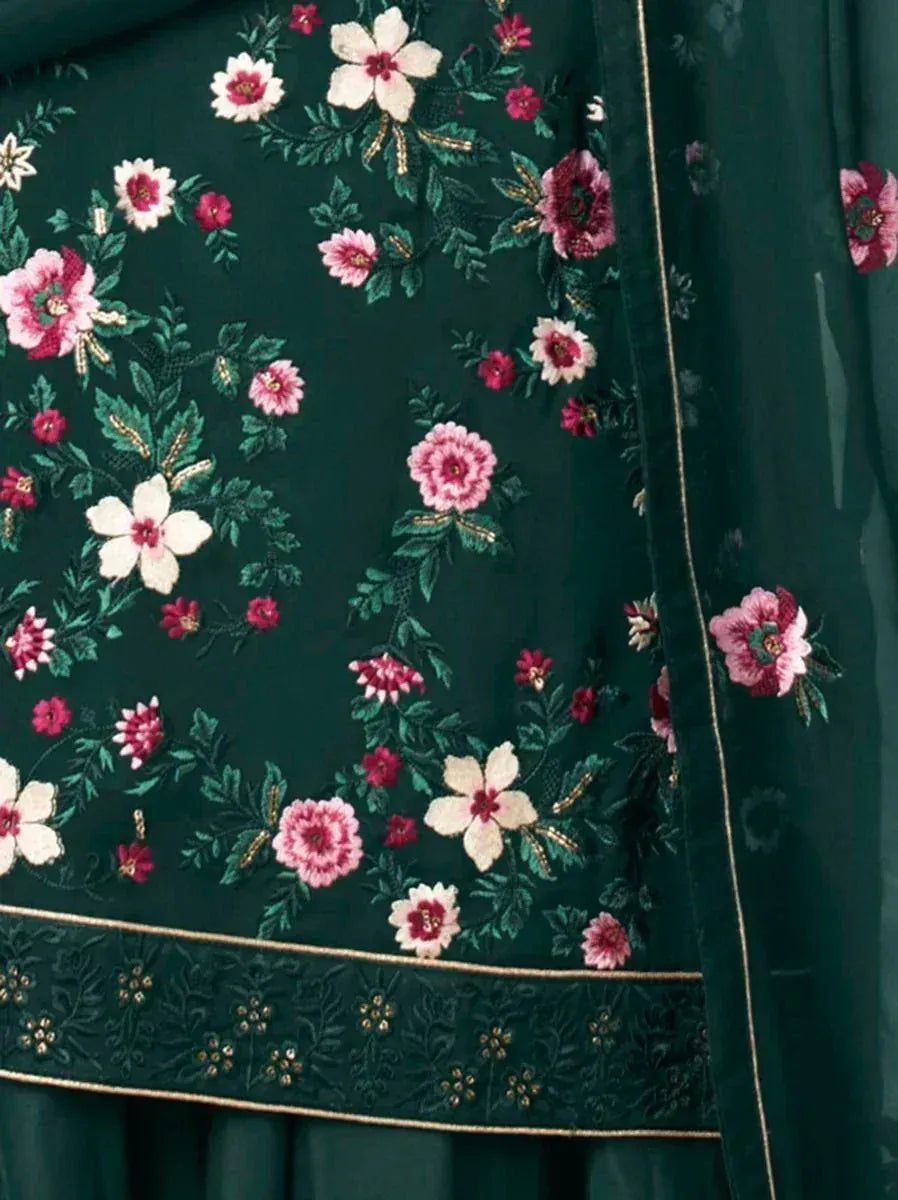 Dark green ethnic fabric with pink and white floral embroidery and gold border detail