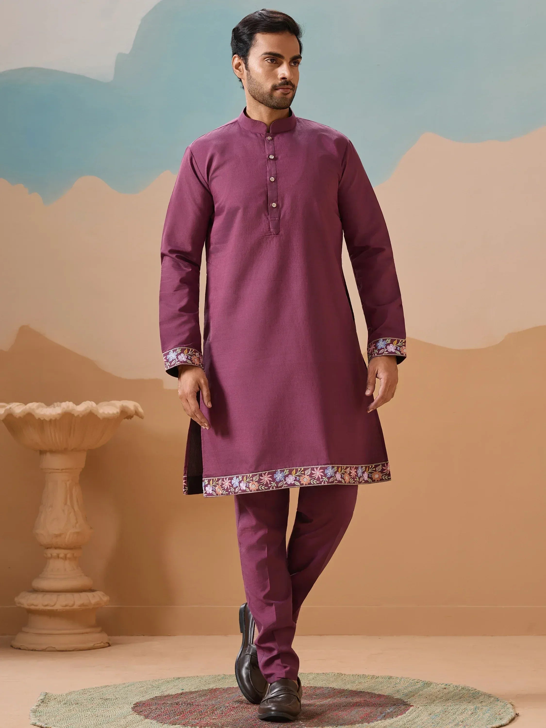 Purple embroidered kurta pajama set with floral detailing, perfect for Indian ethnic occasions.