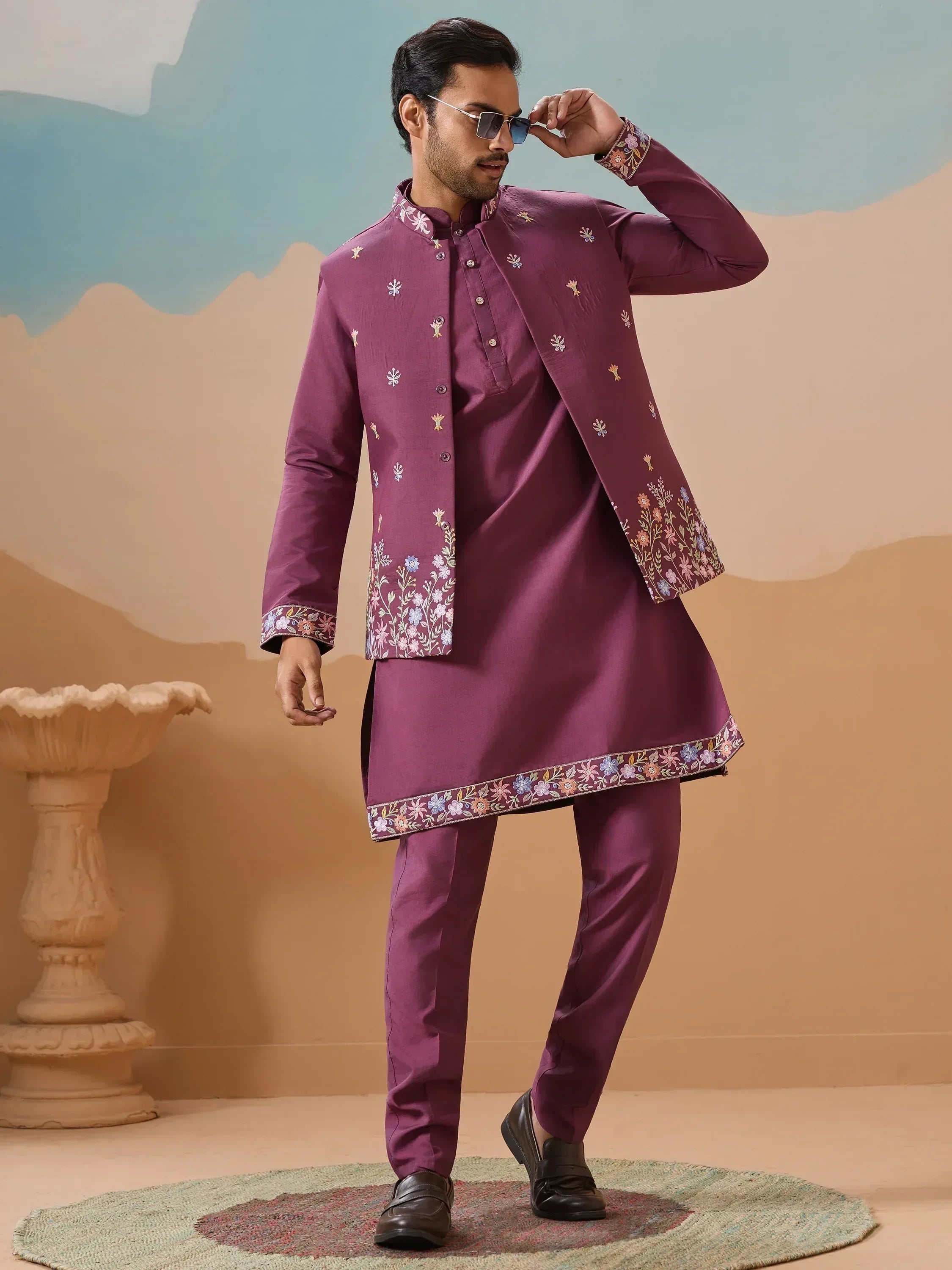 Man in maroon embroidered kurta set with floral detailing, perfect for Indian ethnic occasions