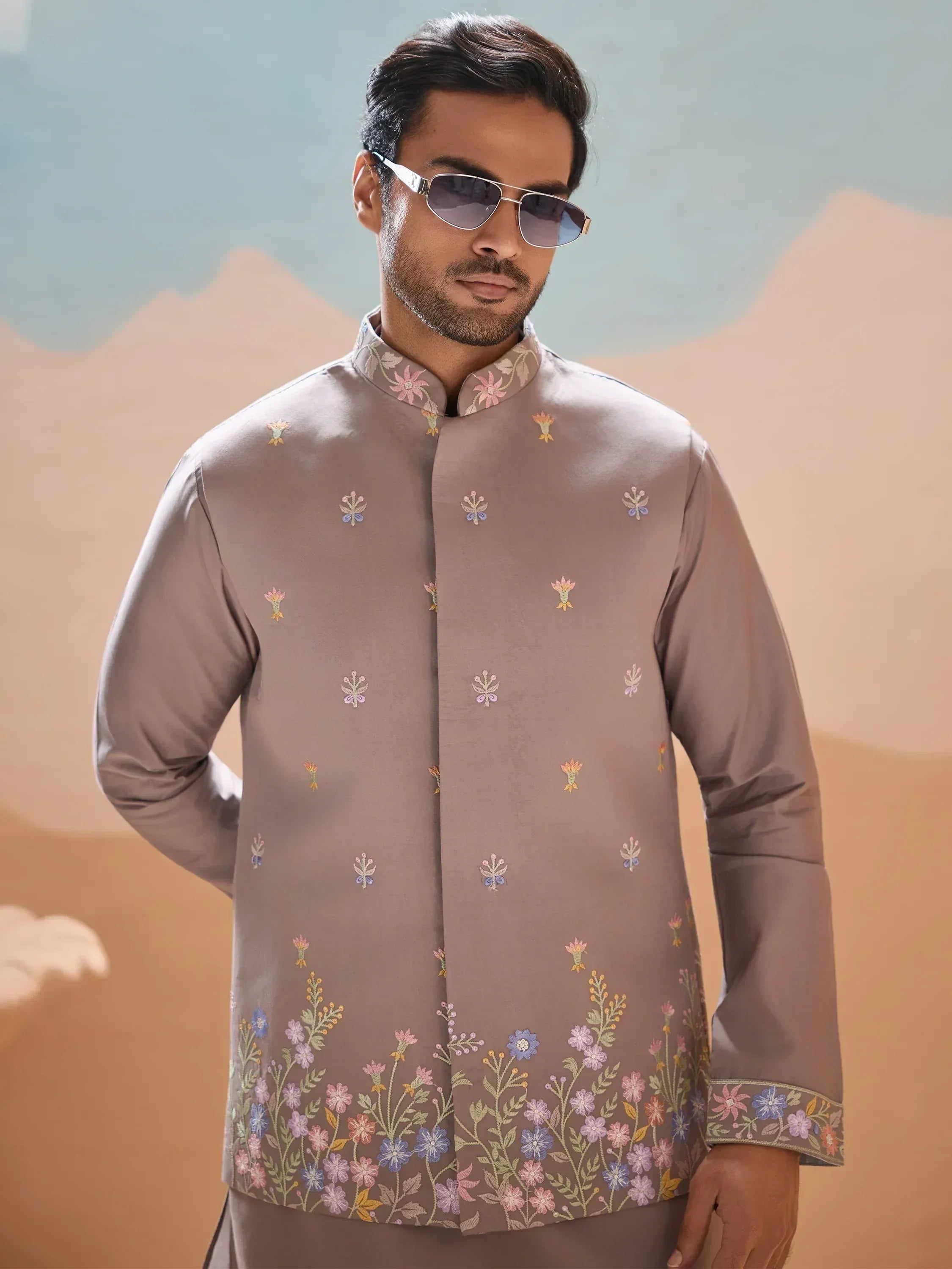 Man in grey embroidered kurta with floral patterns, stylish sunglasses, perfect for Indian ethnic occasions