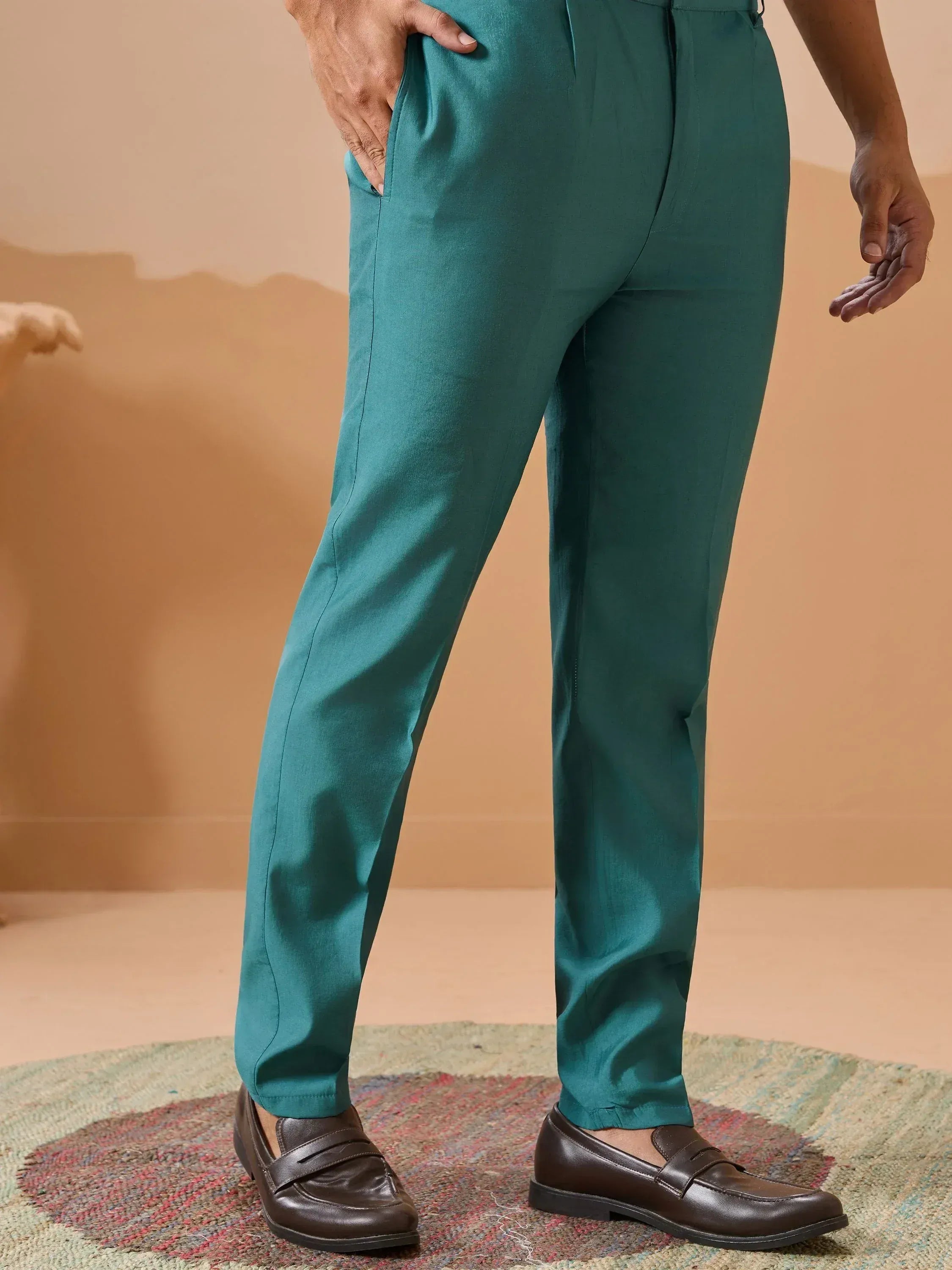 Teal green formal trousers with slim fit, paired with brown loafers, ideal for ethnic or semi-formal occasions.
