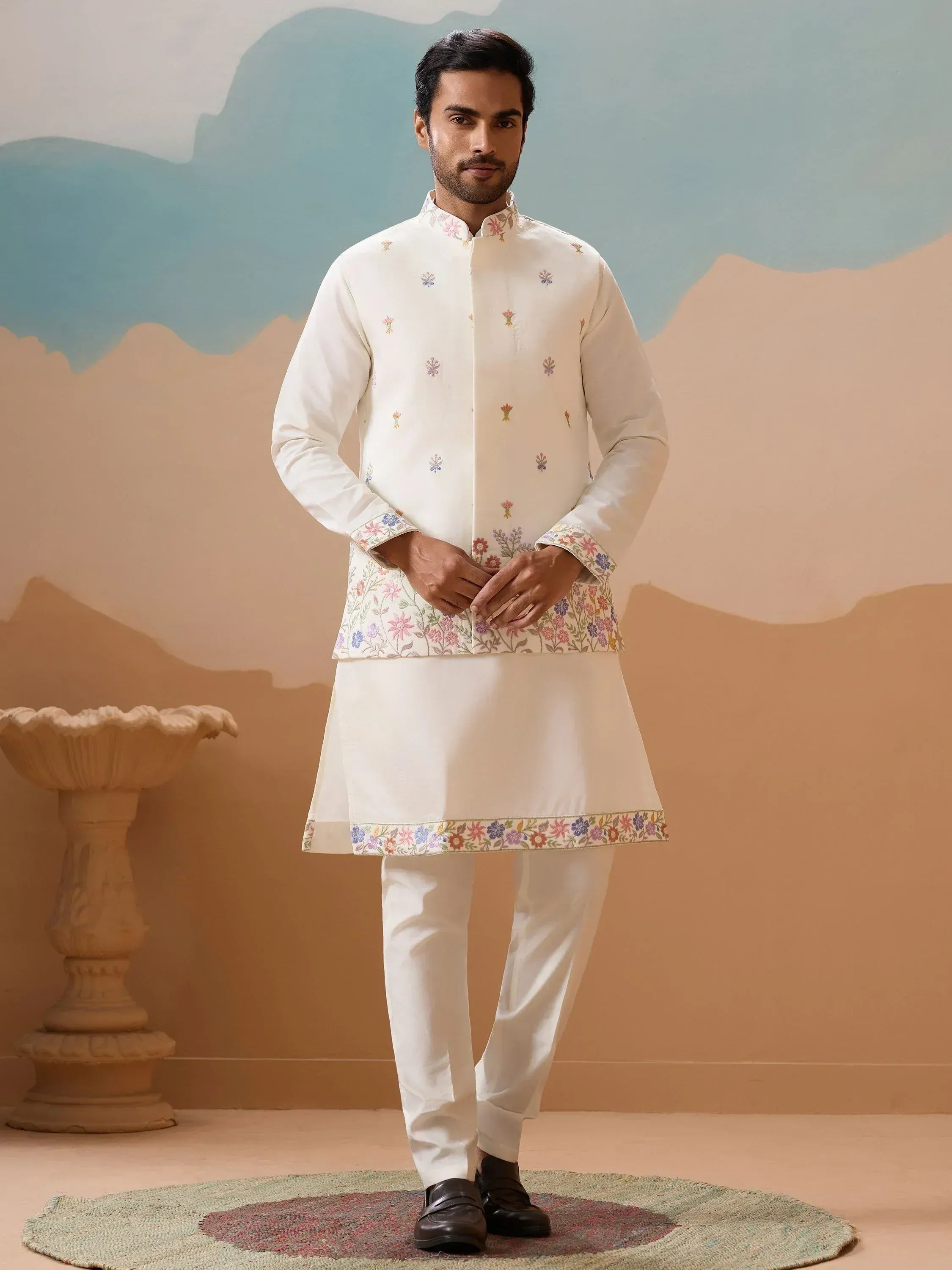 White embroidered kurta pajama set with floral motifs, ideal for Indian ethnic occasions
