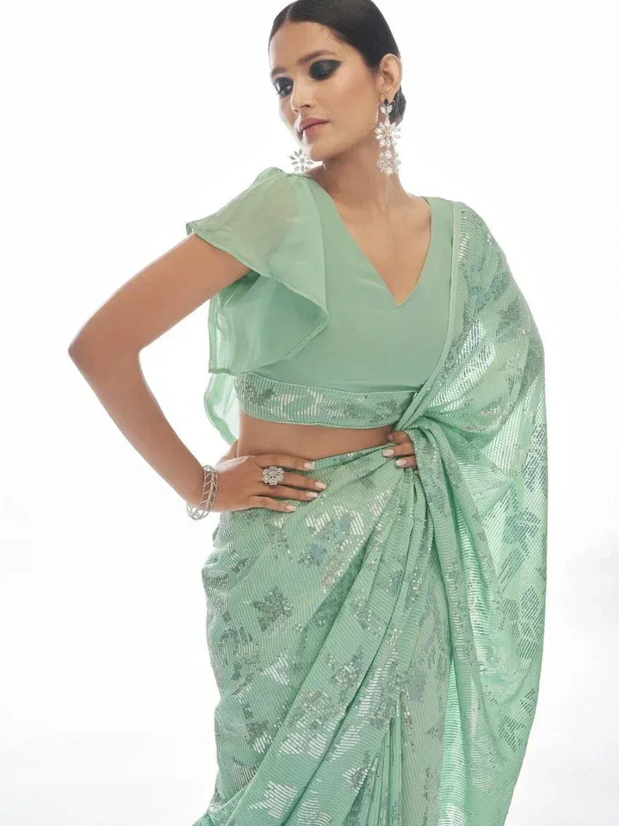 Mint green designer saree with sequin work and ruffled blouse, perfect for ethnic occasions