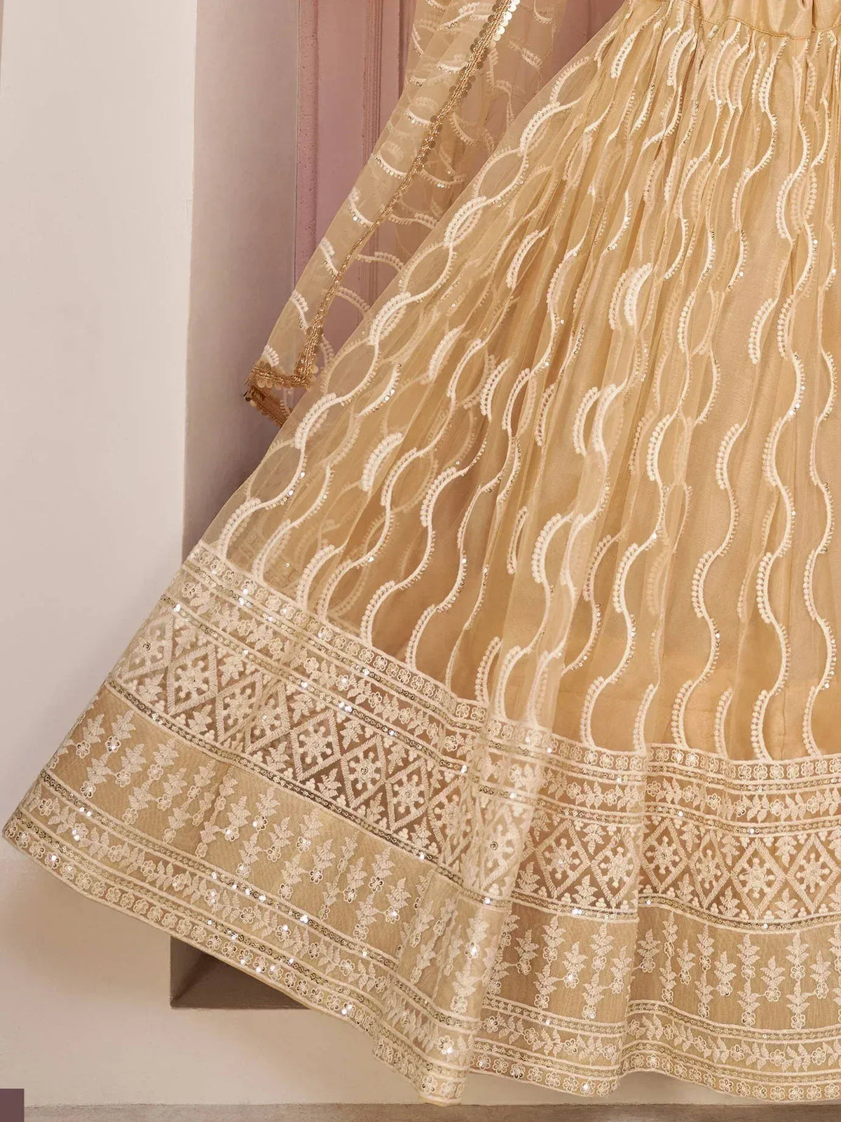 Beige embroidered lehenga with sequin detailing and scalloped hem, ideal for Indian ethnic wear occasions