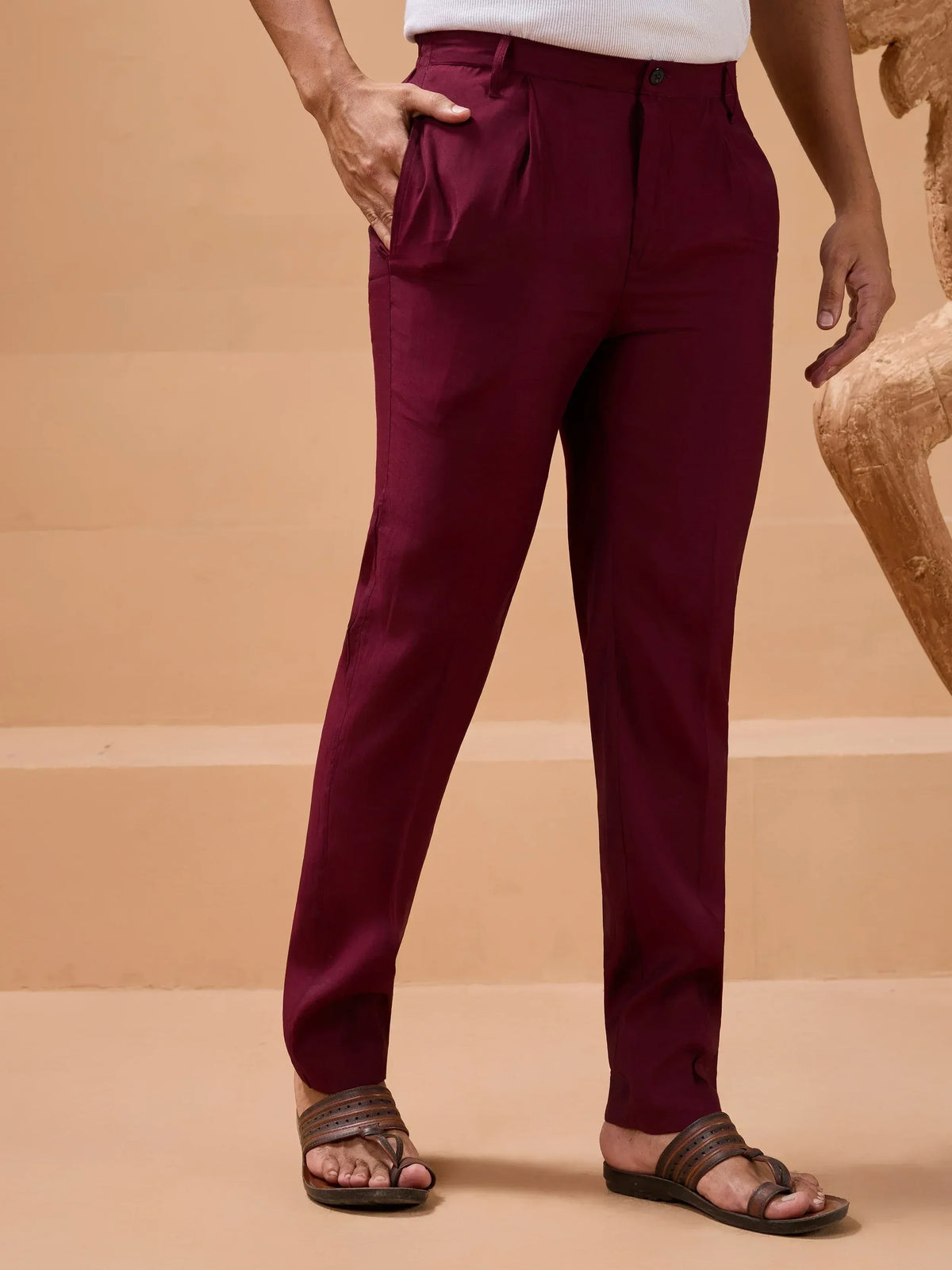 Men's maroon pleated trousers with white top and sandals, ethnic wear style