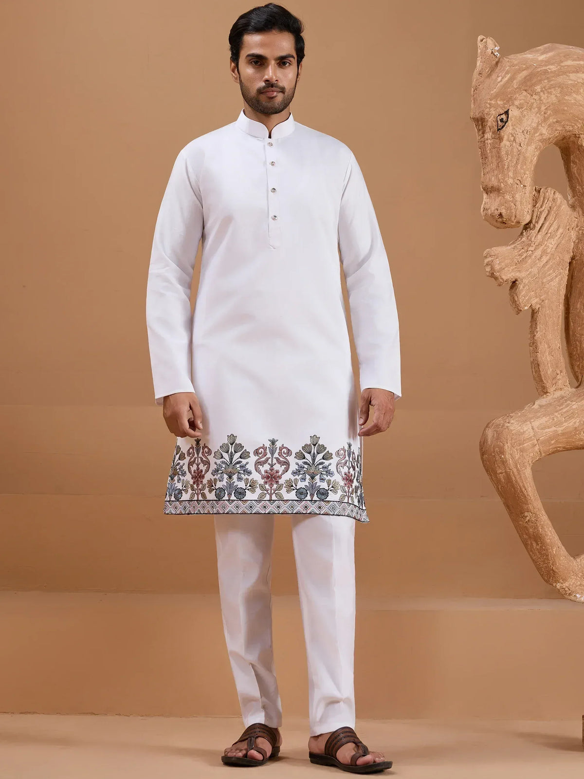 White kurta with floral embroidery, paired with matching pants, ideal for Indian ethnic wear occasions