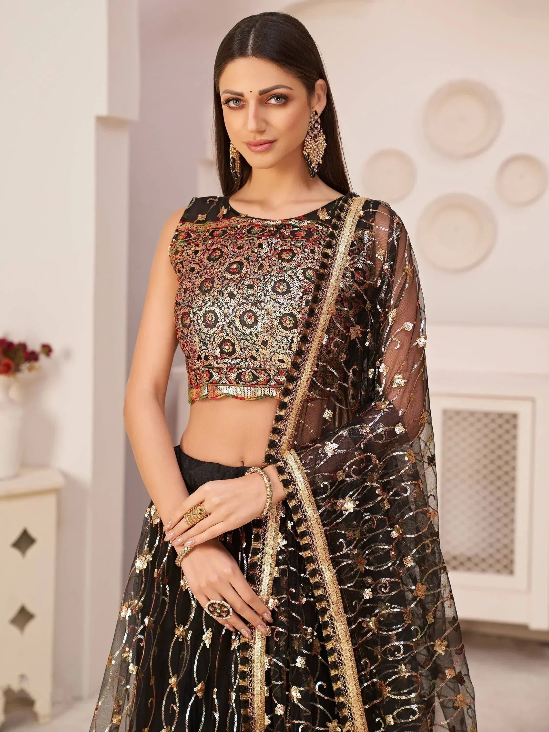 Black embroidered lehenga choli with gold sequins, perfect for Indian ethnic wear and festive occasions.