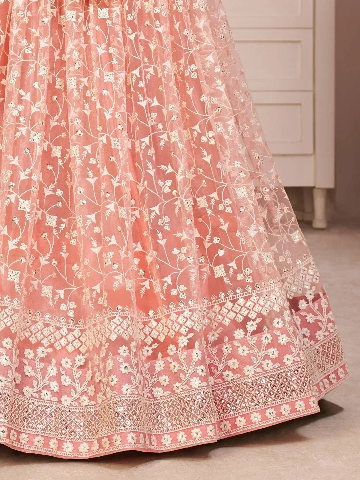 Pink embroidered lehenga with floral and geometric patterns, ideal for Indian ethnic wear