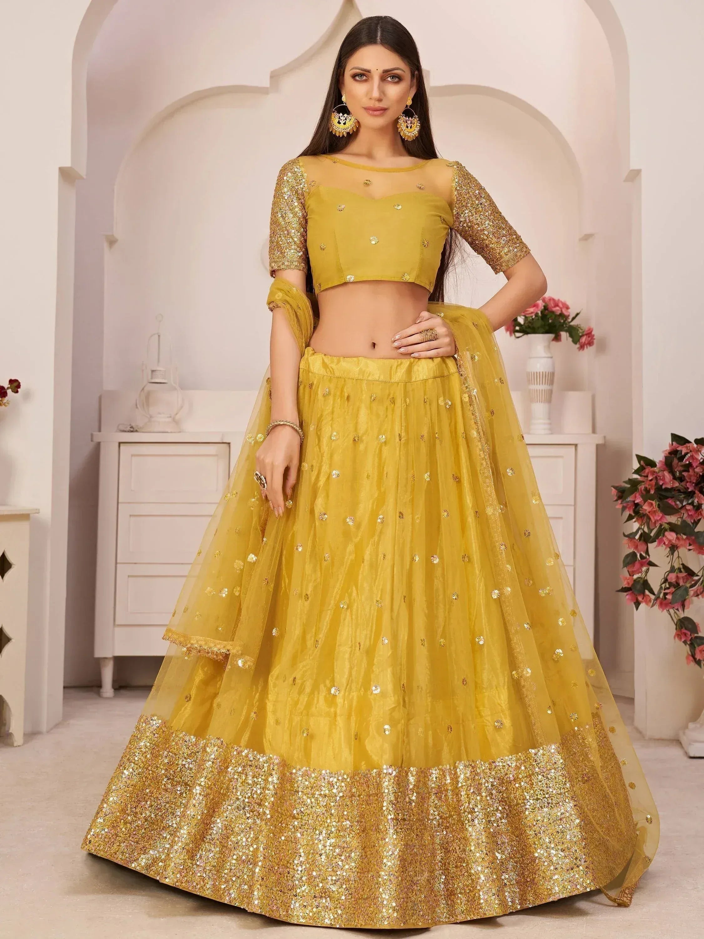 Yellow designer lehenga choli with sequin work and sheer sleeves for Indian ethnic wear