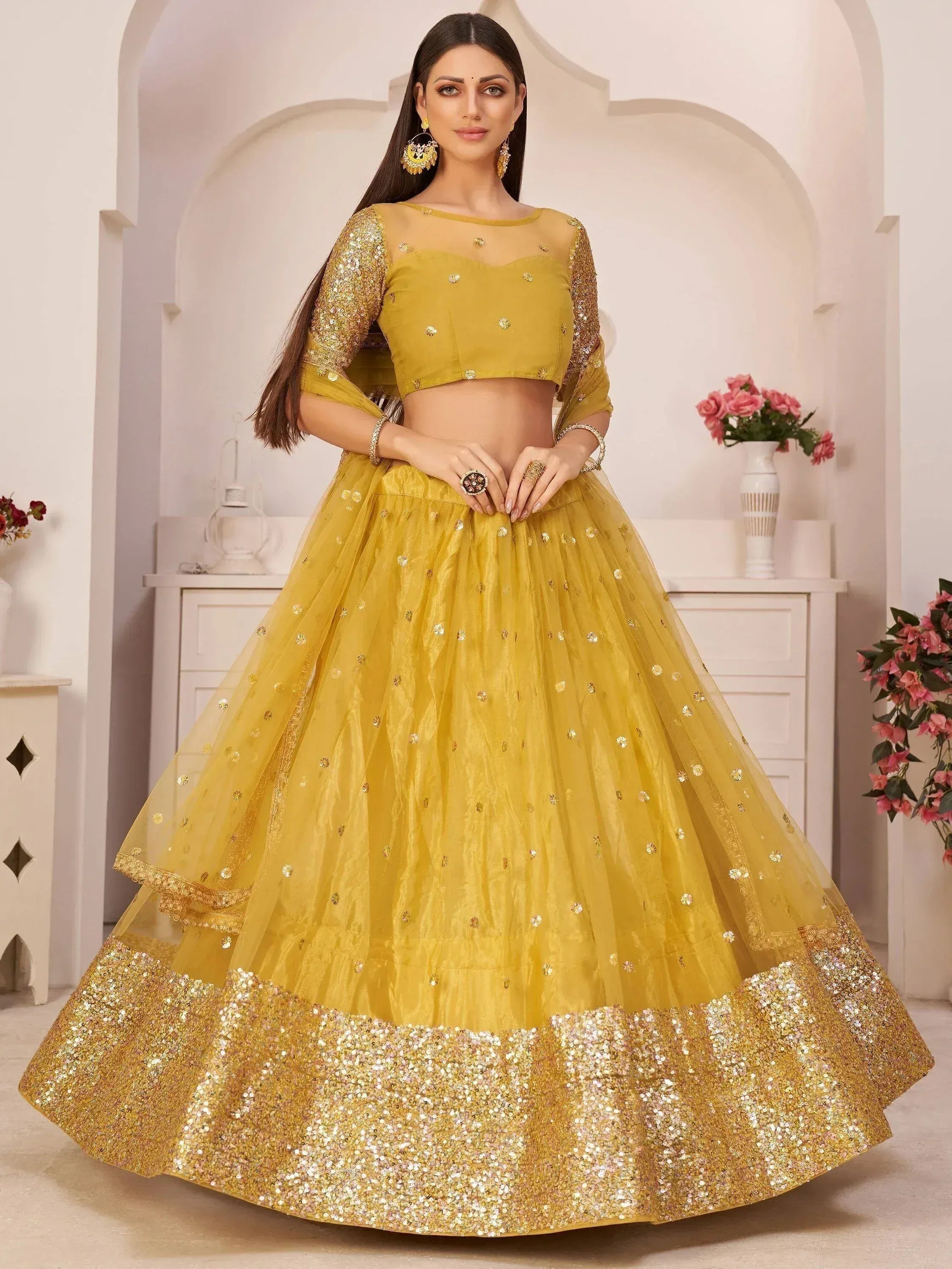 Yellow designer lehenga choli with gold sequins and embroidery, perfect for Indian ethnic wear events.