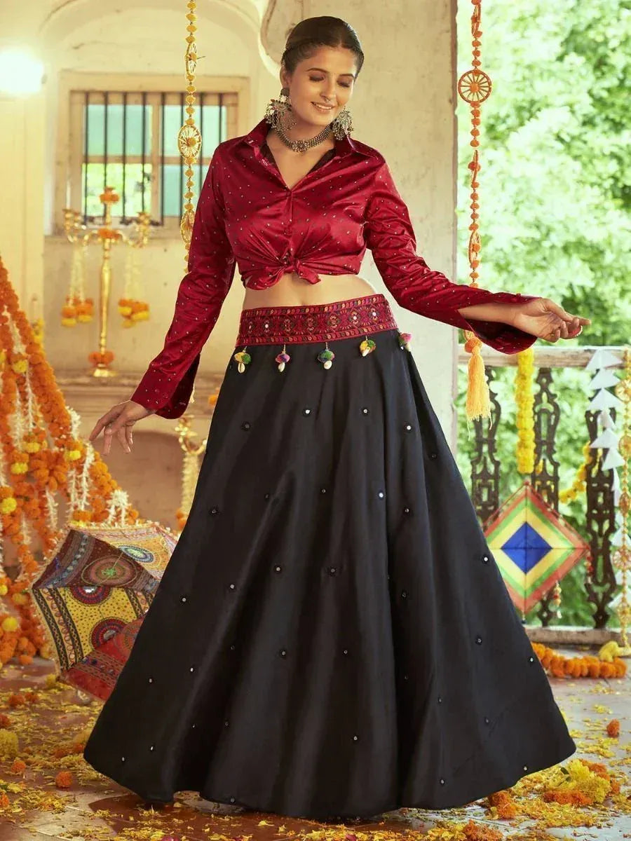 Woman in maroon blouse and black lehenga with mirror work, festive Indian ethnic wear