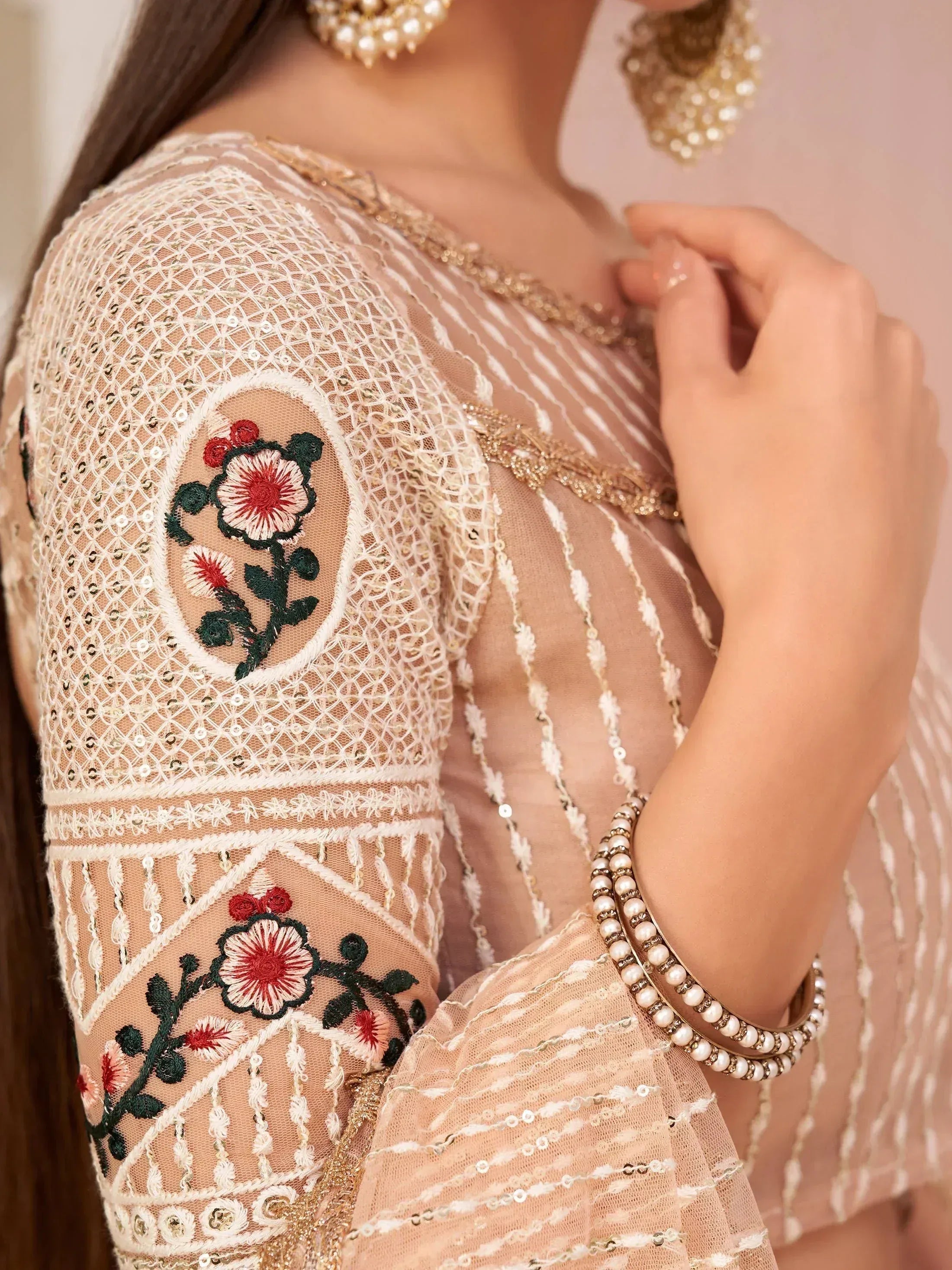 Elegant ethnic wear with floral embroidery, sequins, and pearl jewelry for Indian occasions