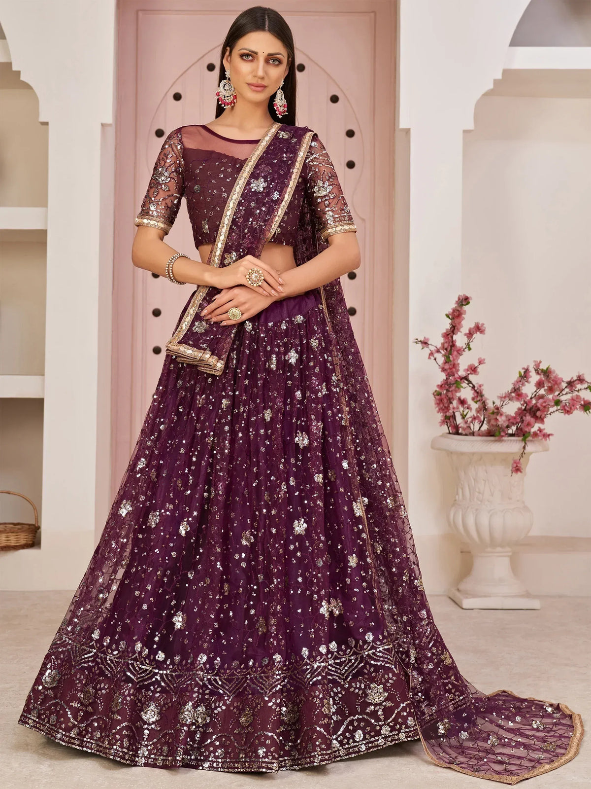 Elegant purple lehenga choli with intricate gold embroidery and sequins, perfect for Indian ethnic wear.