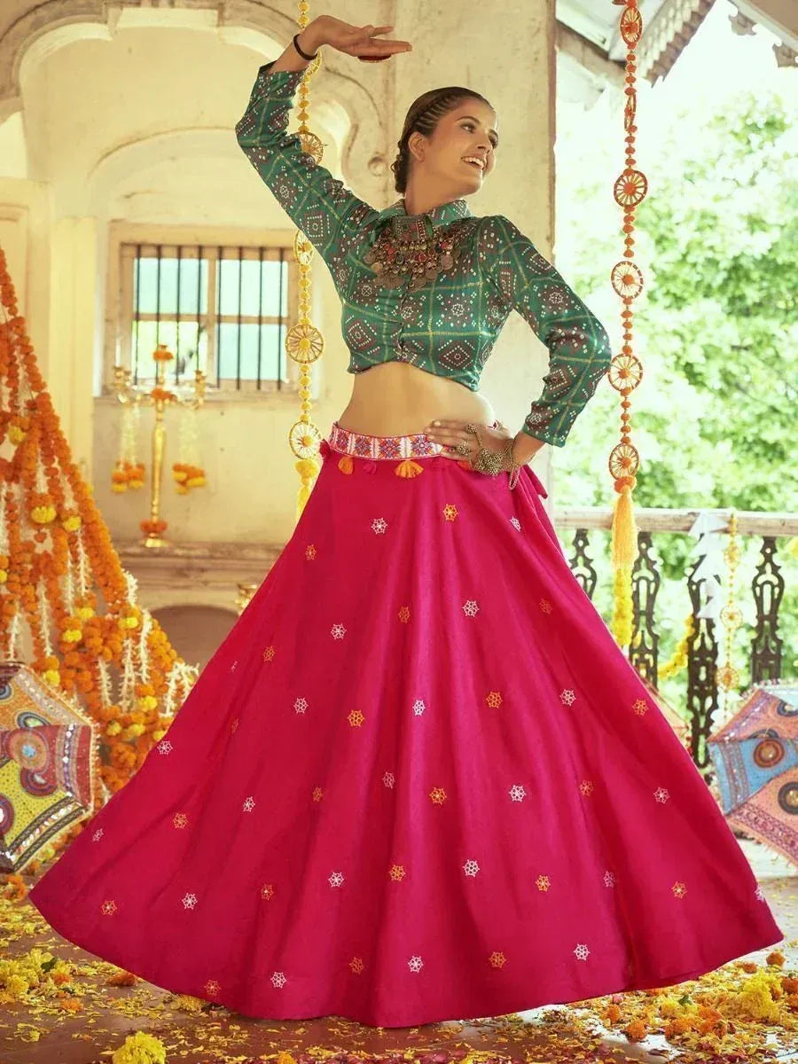 Woman in vibrant pink lehenga choli with green embroidered blouse, festive Indian ethnic wear