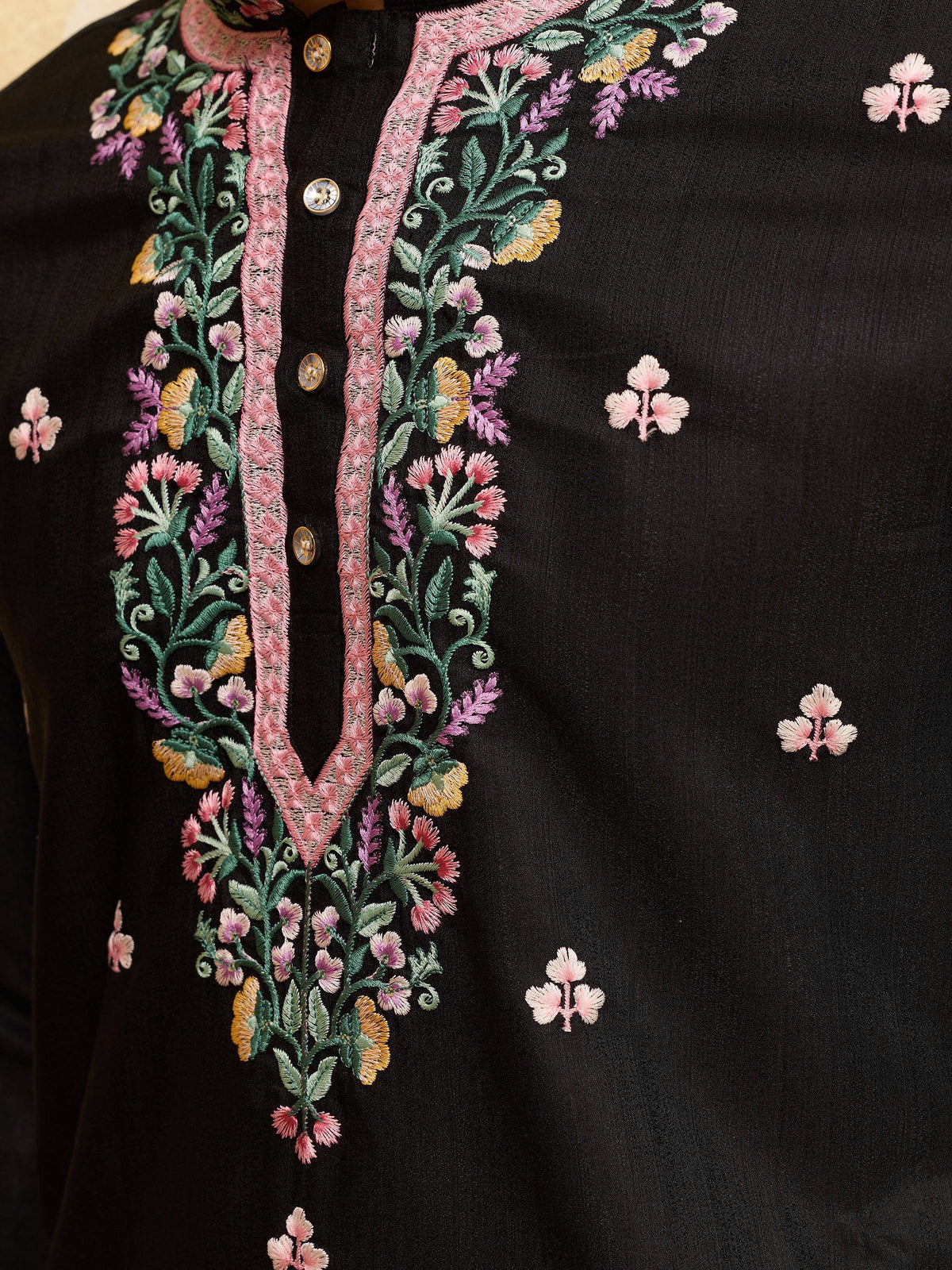 Close-up of black ethnic kurta featuring intricate floral embroidery on the placket