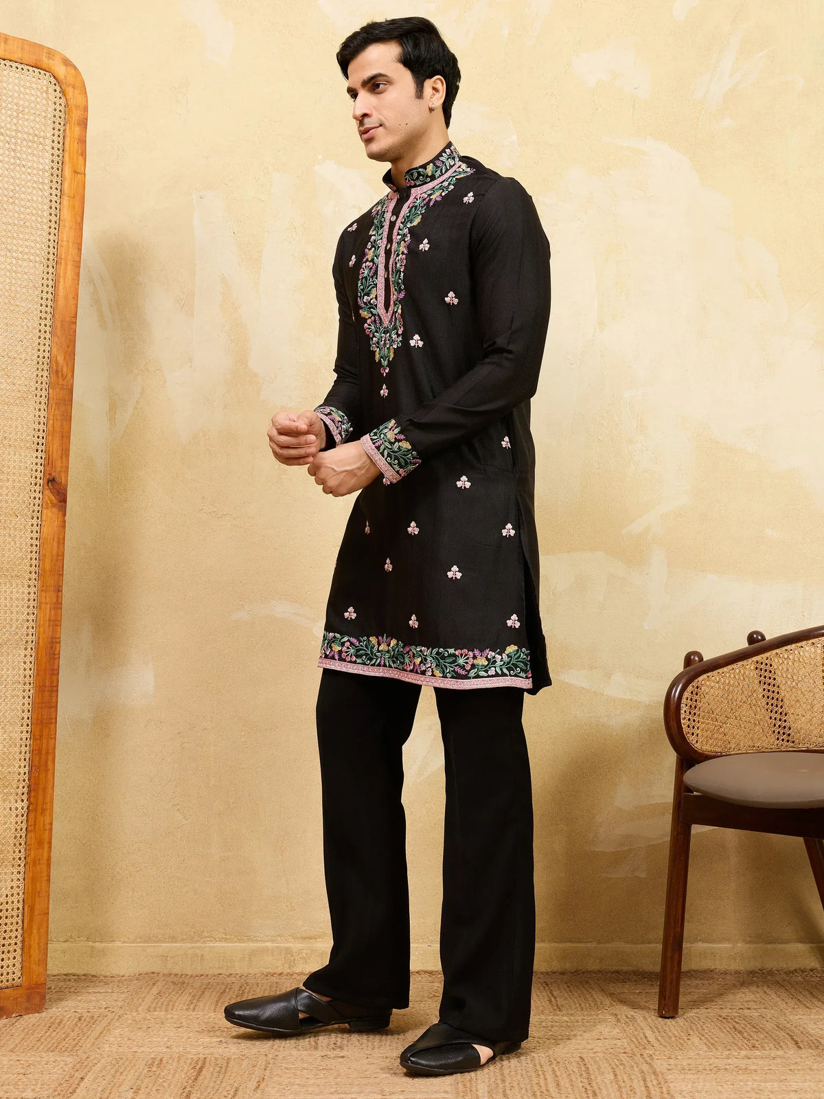 Man wearing a black embroidered ethnic kurta set with matching trousers