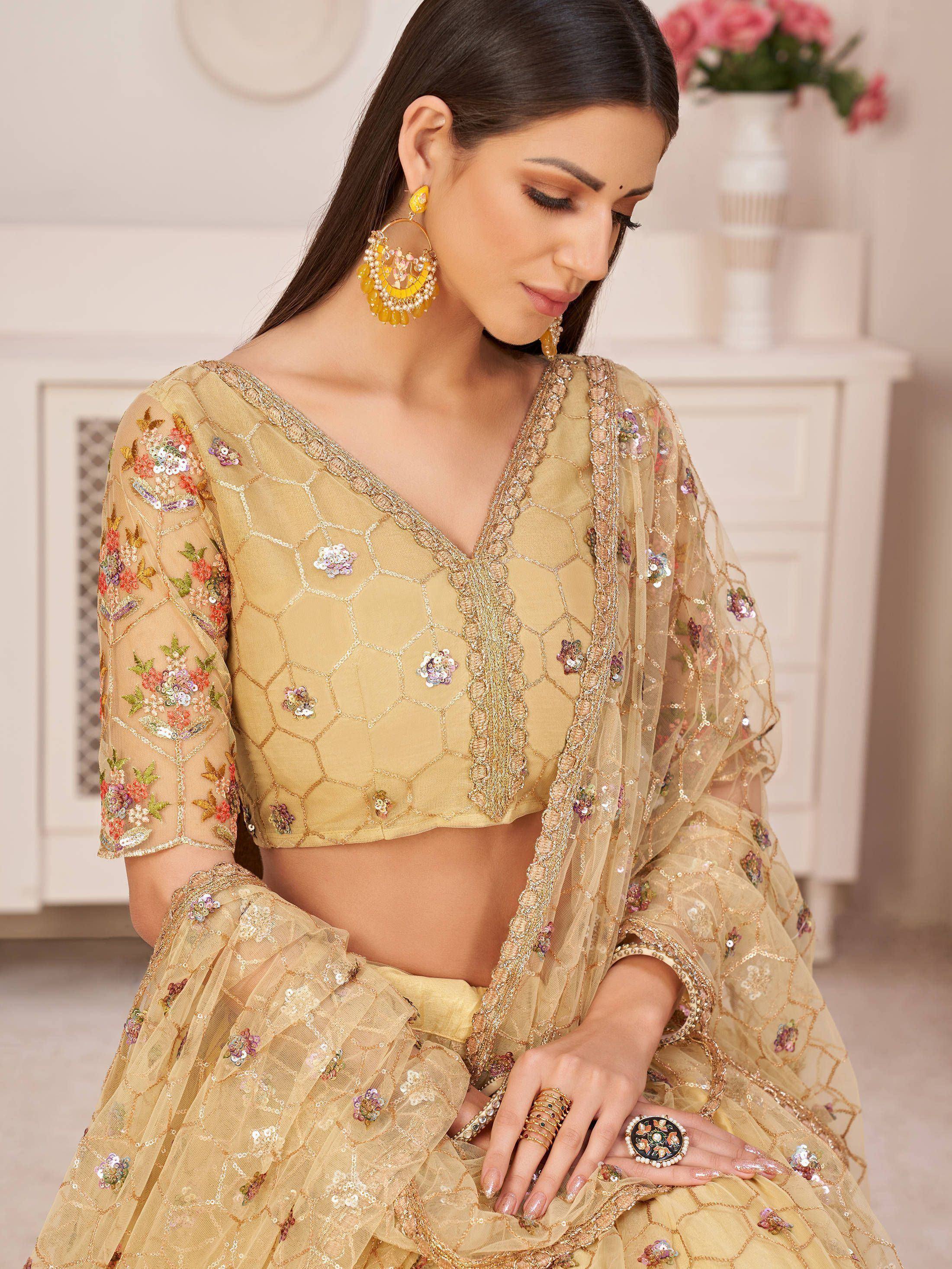 Elegant gold lehenga choli with floral sequin embroidery and sheer dupatta, perfect for Indian ethnic occasions.