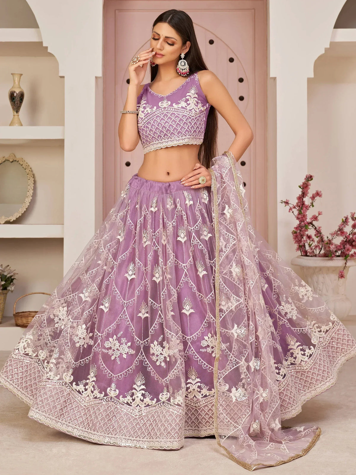 Purple embroidered lehenga choli with floral patterns and gold trim, perfect for Indian ethnic wear occasions.