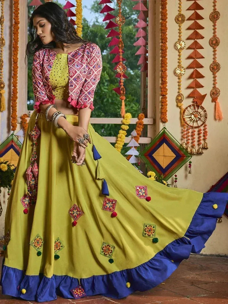 Vibrant yellow lehenga choli with embroidered motifs and blue ruffle hem, perfect for Indian ethnic occasions