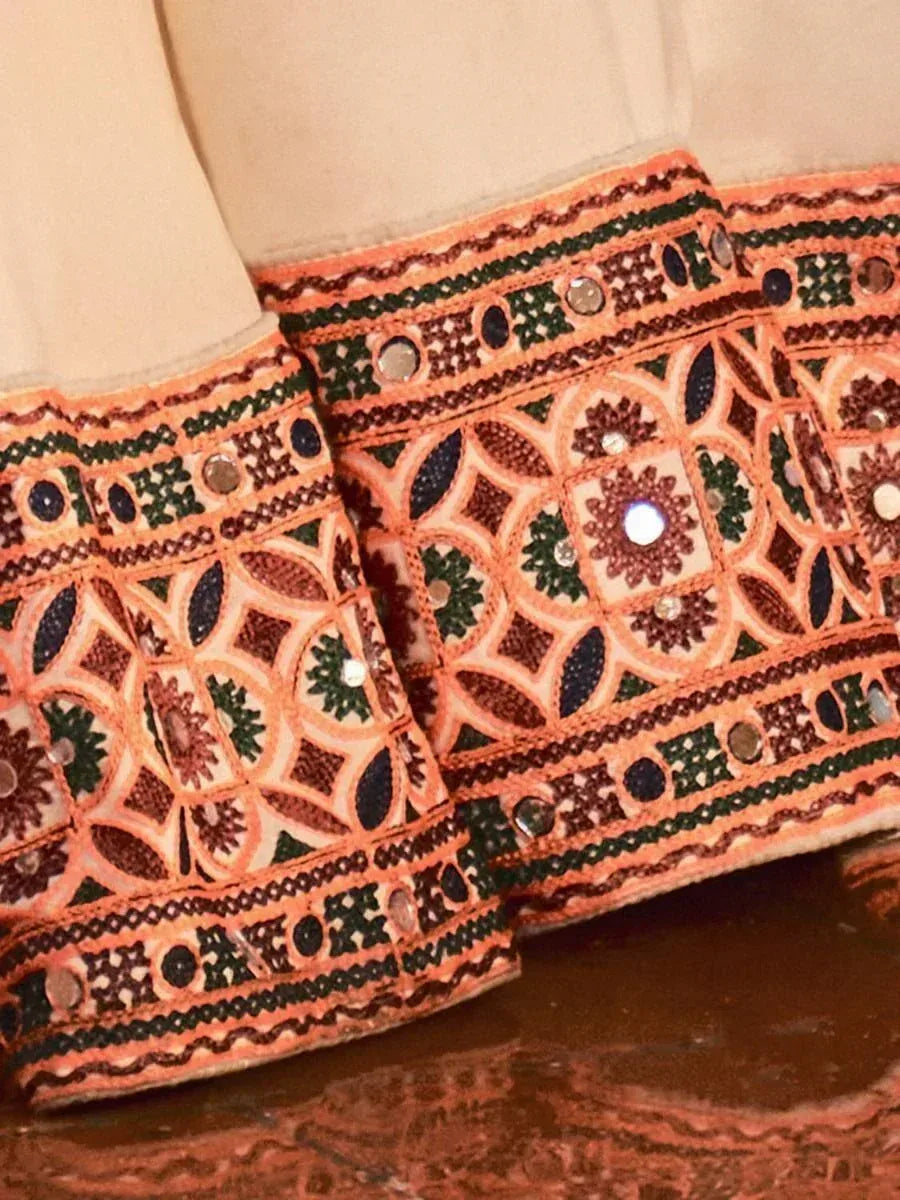 Ethnic wear with intricate orange, green, and brown mirror embroidery on sleeves
